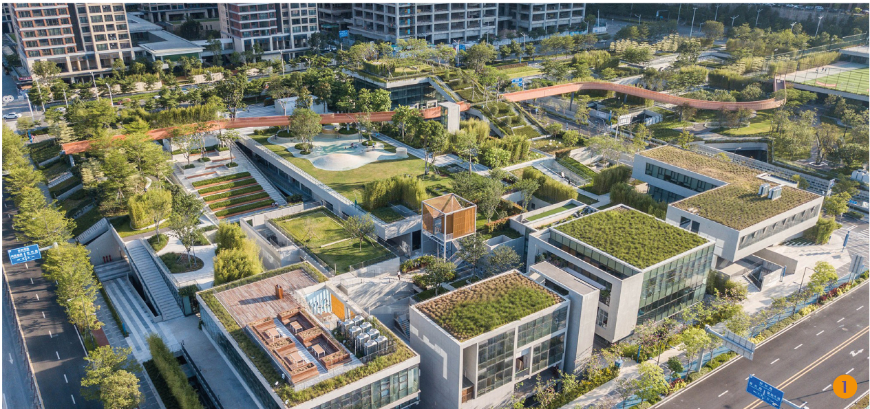 Aerial view of multiple green roofs and planted terraces surrounding residential towers in daylight