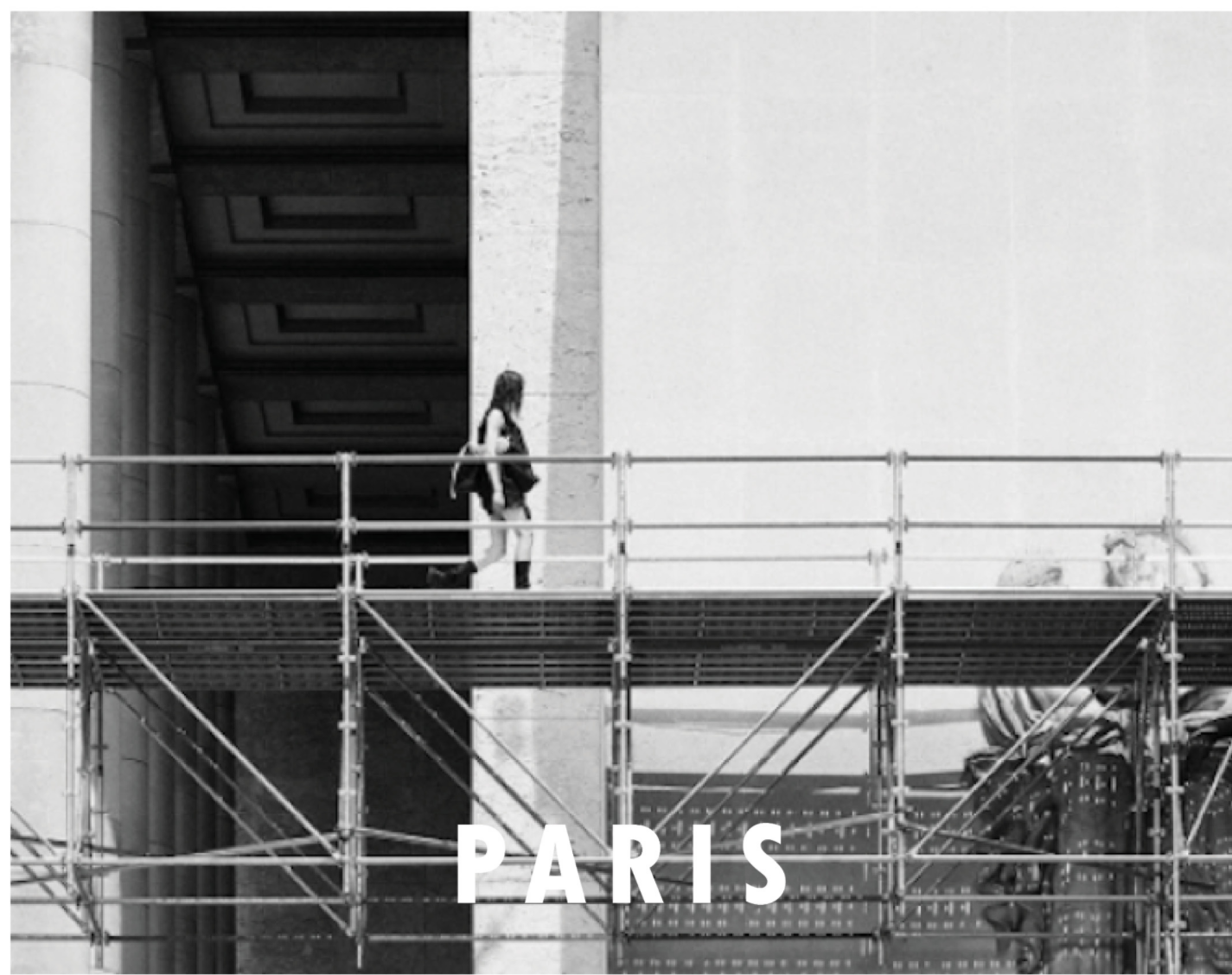 A passerby walks a temporary elevated scaffold path, blending daily life with ongoing architectural transition.