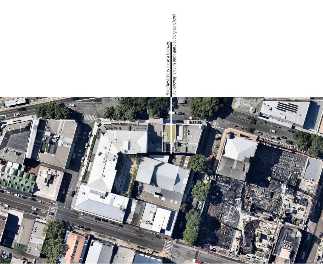 Aerial view of a central courtyard surrounded by white-roofed structures between street traffic and adjacent buildings