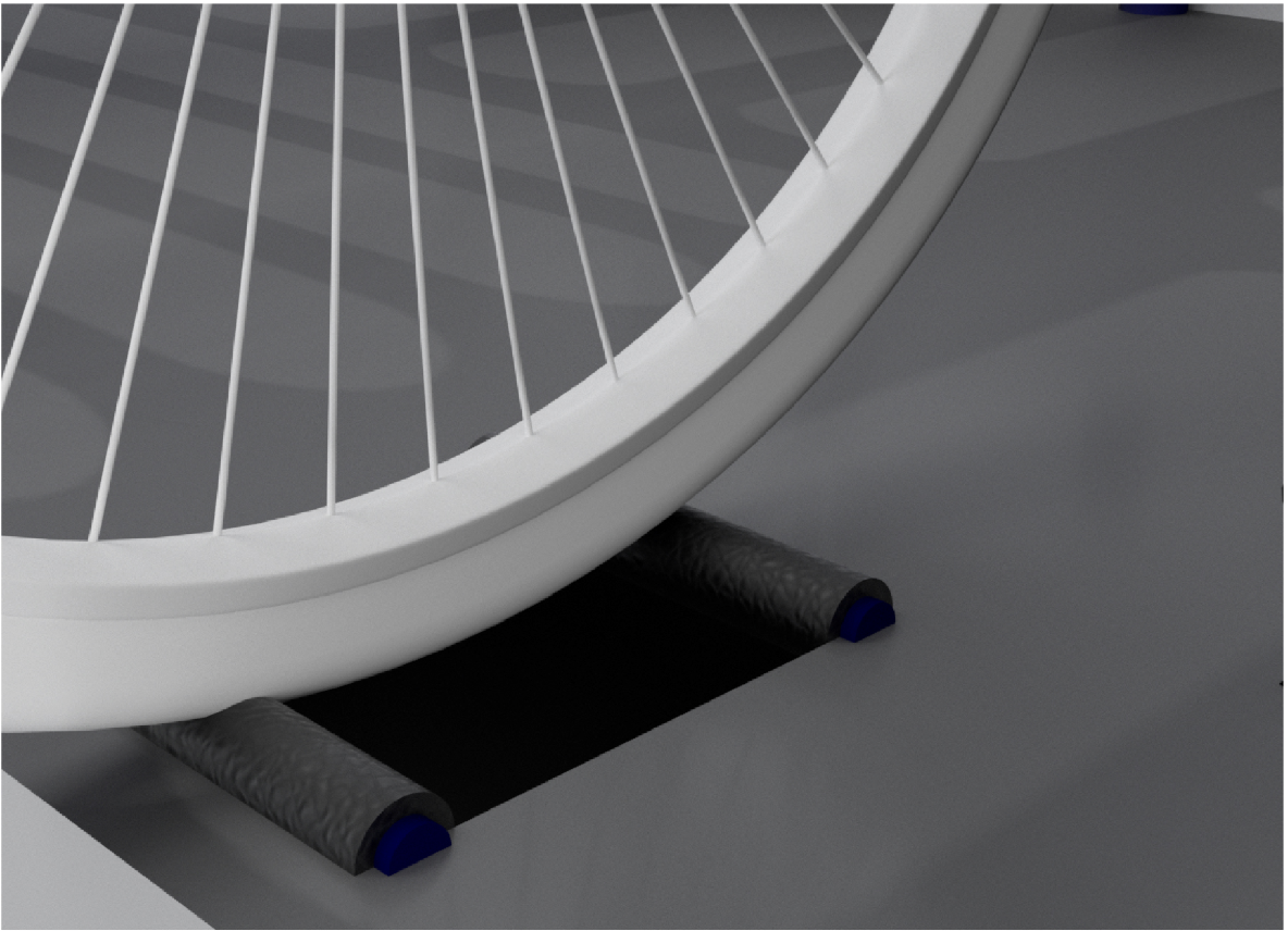 Rear bicycle wheel rests on rollers to generate energy while remaining stationary.