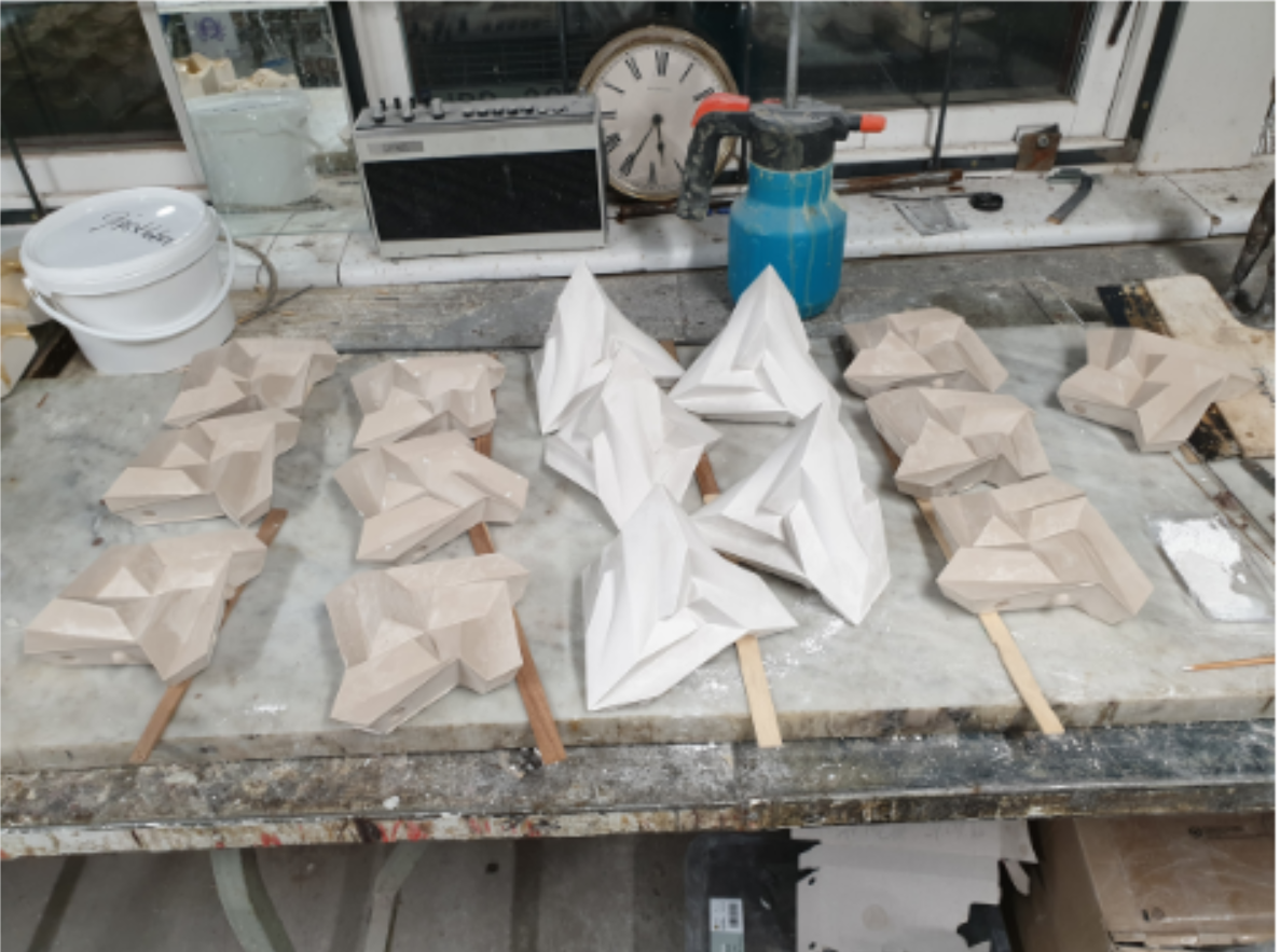 A series of molds and casts showcasing the fabrication process from digital file to physical form.