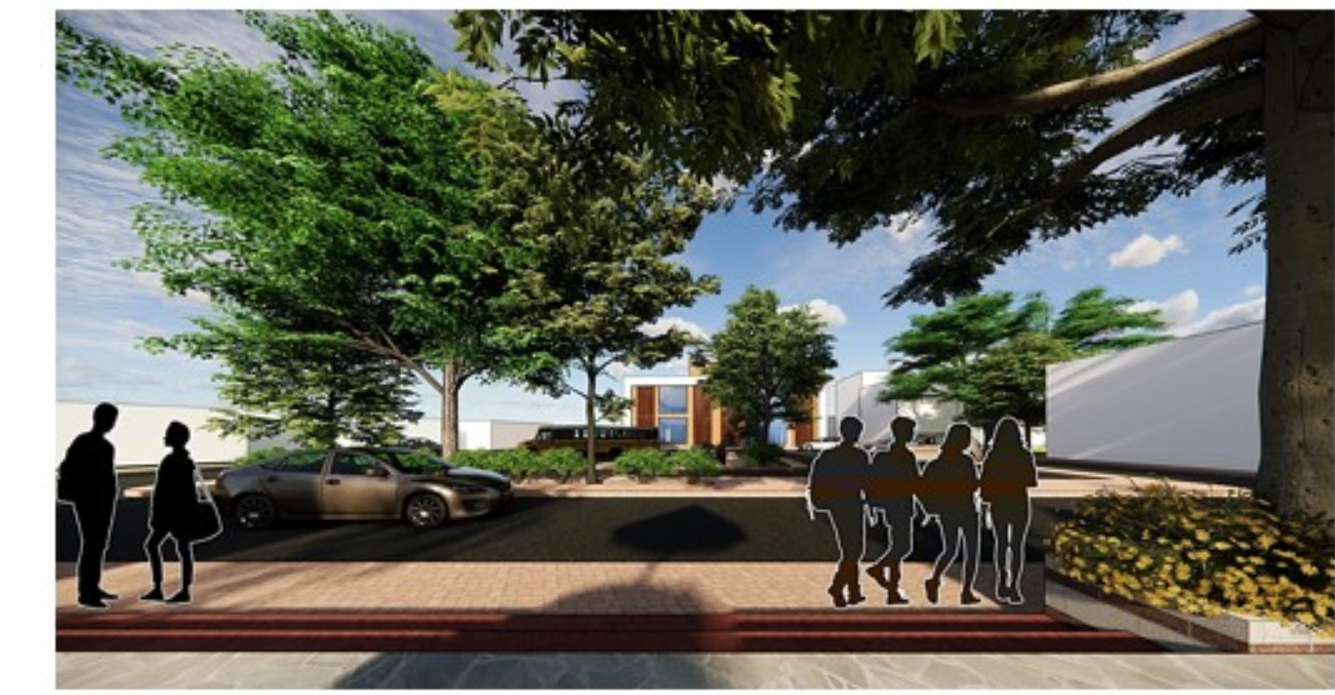 A welcoming threshold connecting the community to the revitalized mill complex, framed by greenery and restored brickwork.