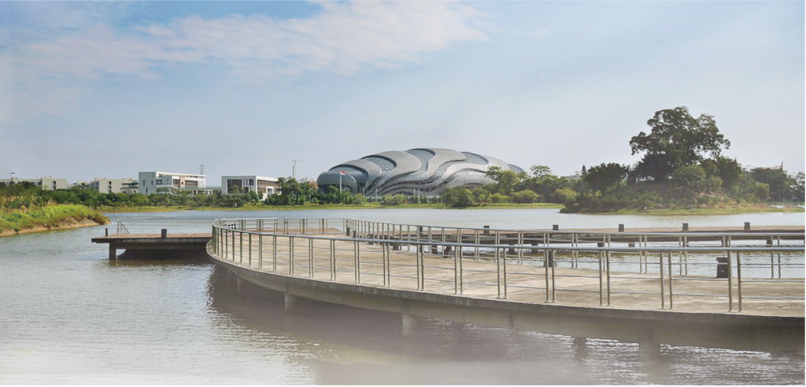 The curved walkway around the lake connects various activity zones — a potential core of future public interaction.