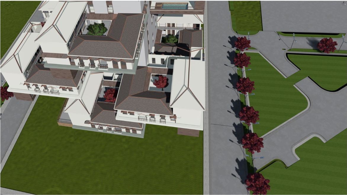 Aerial view of the white residential complex with dark flat roofs and interior courtyards surrounded by green lawns