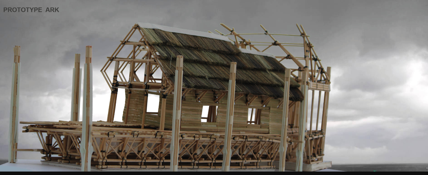Physical model of a timber-framed shelter with exposed joinery and partial roof under an overcast sky