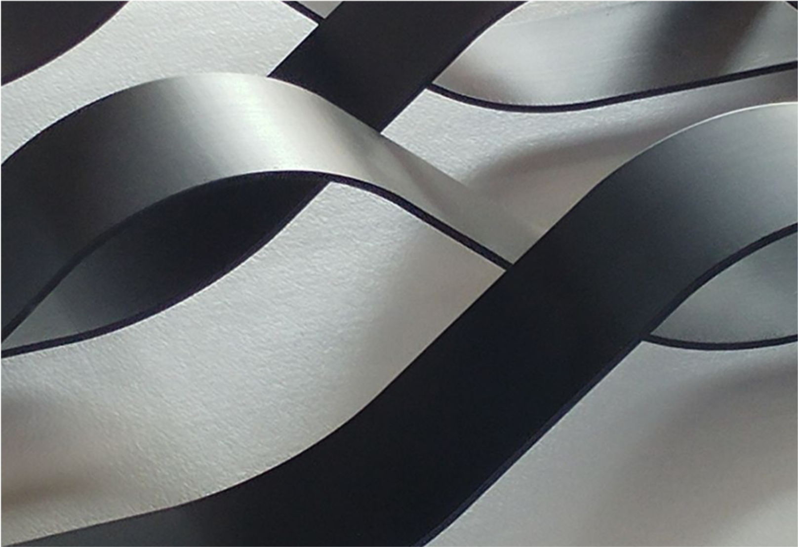 Close-up detail of the bent metal strips, revealing the fluid wave geometry inspired by ocean currents.