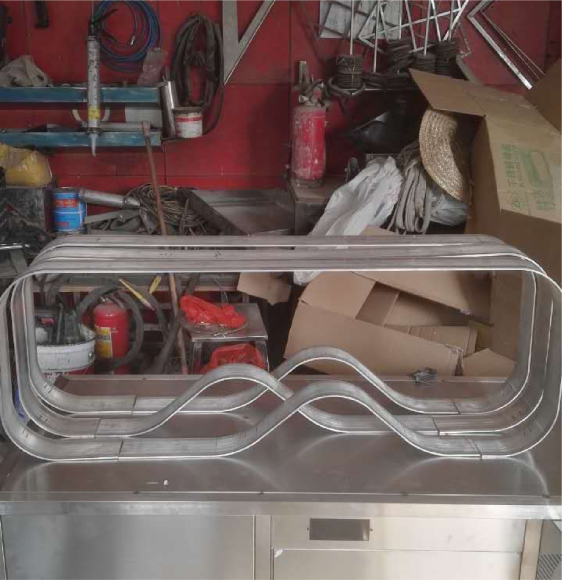 Fabrication stage of the Arctic Coffee Table, showcasing the metal bending process behind its wave-based structure.