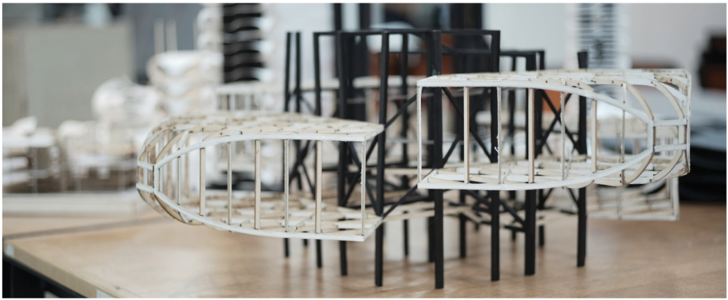 Physical structural prototype testing the curved frame system and cantilevered extensions.