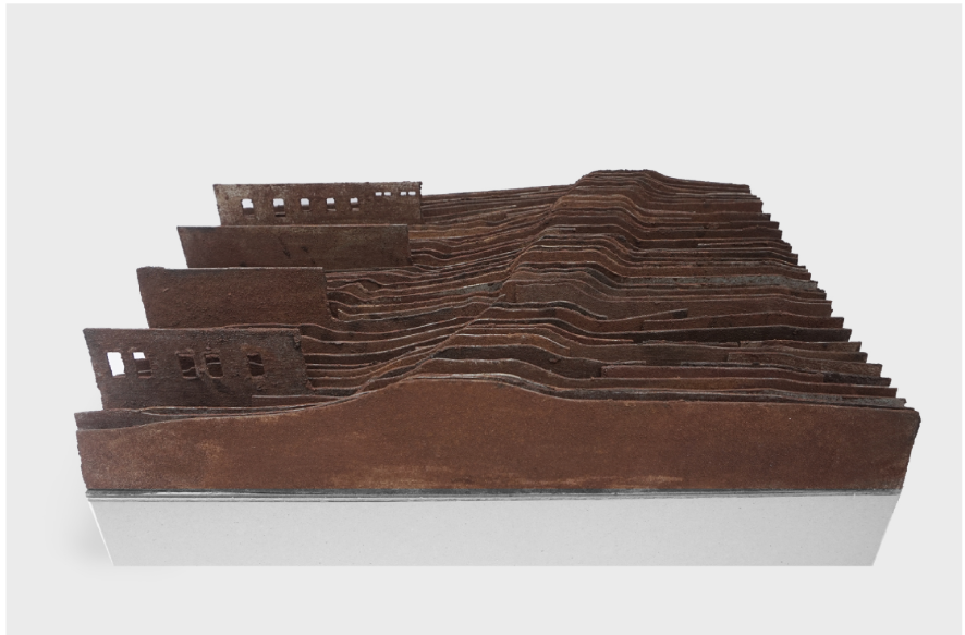 Physical model expressing stratified erosion as architectural and territorial form.