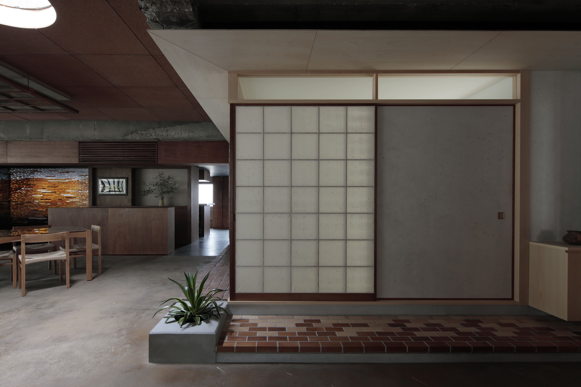 Closed translucent panel beside open shoji screen revealing the interior dining space beyond