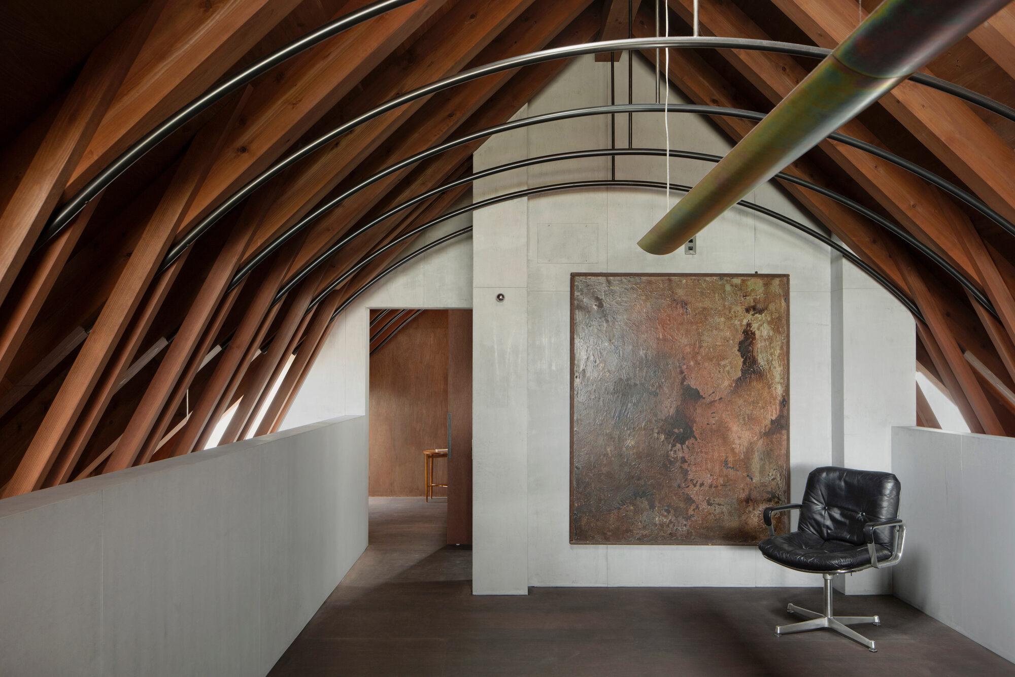 Upper level with curved laminated timber ribs arching over white painted walls