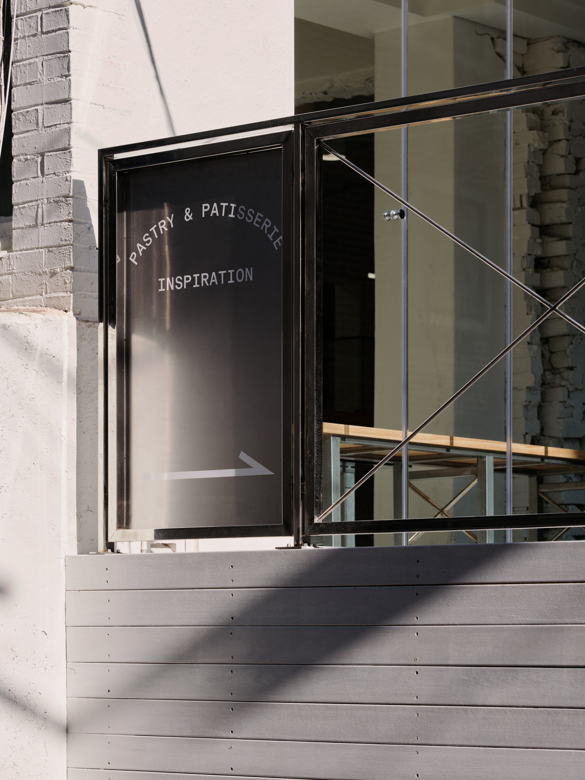 Detail of the entrance terrace with a Pastry & Patisserie Inspiration sign