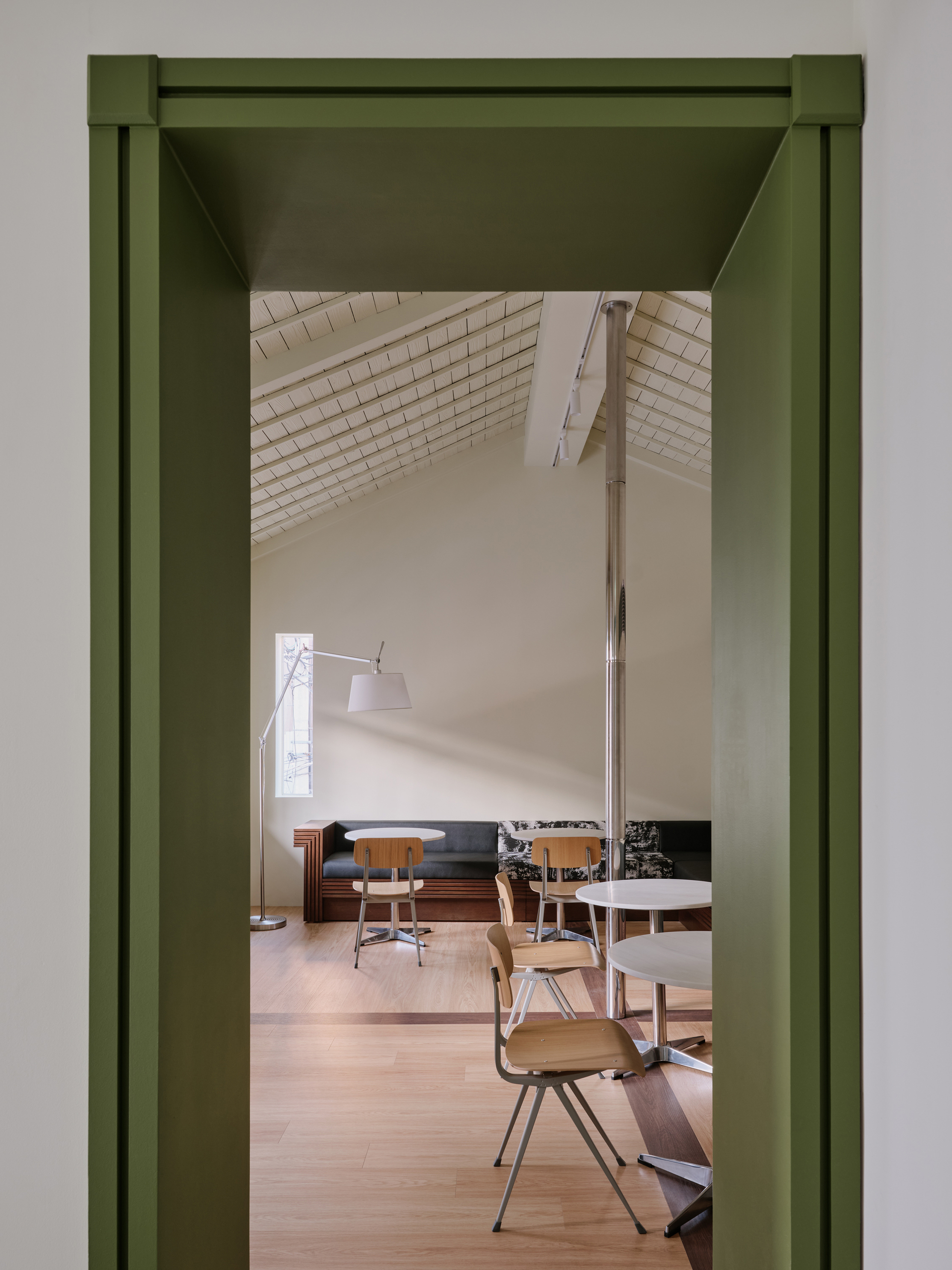Looking through a green-framed doorway into the upper-level cafe with its tiled vaulted ceiling