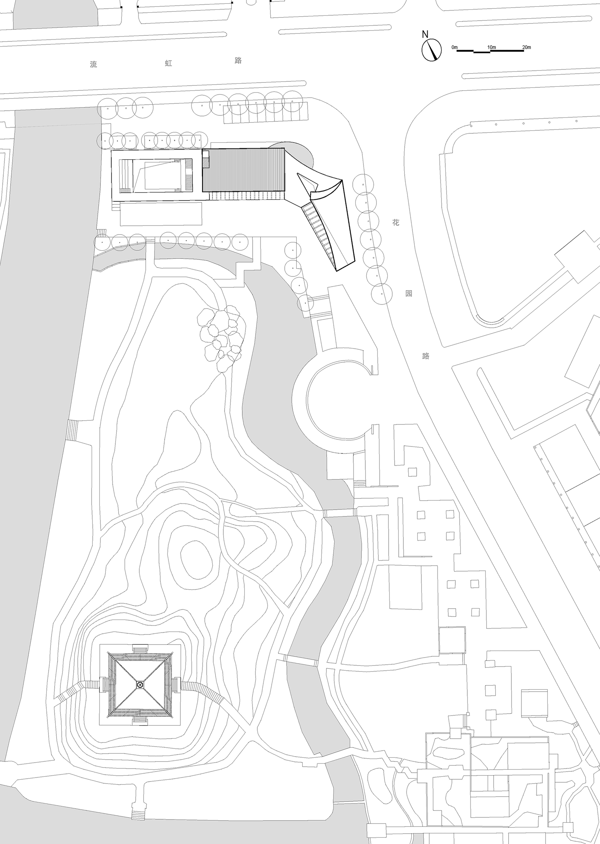 Site plan drawing showing building footprints with curved pathways and topographic contours around a central pond