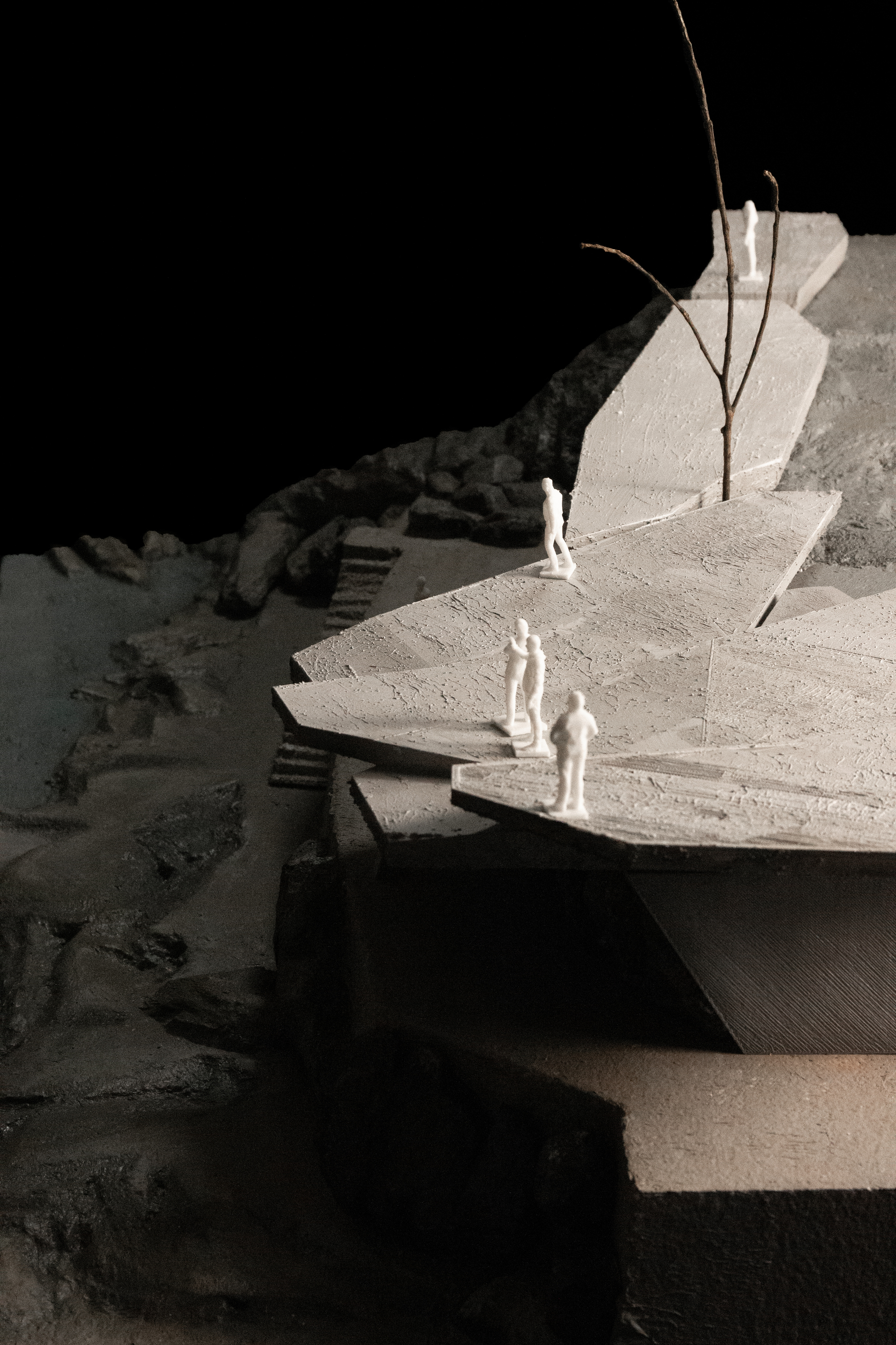 Physical model showing cantilevered roof platforms and stairs carved into the hillside with figures and trees
