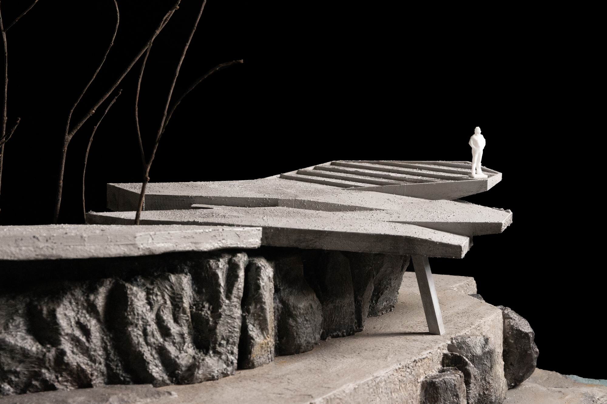 Detail of the model showing a curved deck with stairs bridging over the rocky terrain