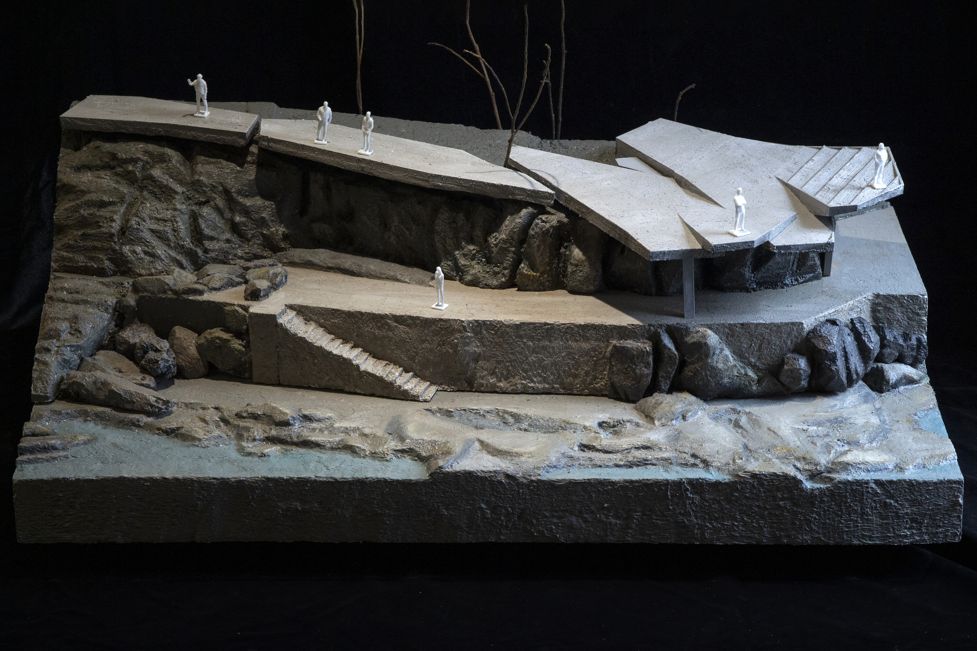 Overall view of the physical model set on a base showing the waterfront and rocky landscape