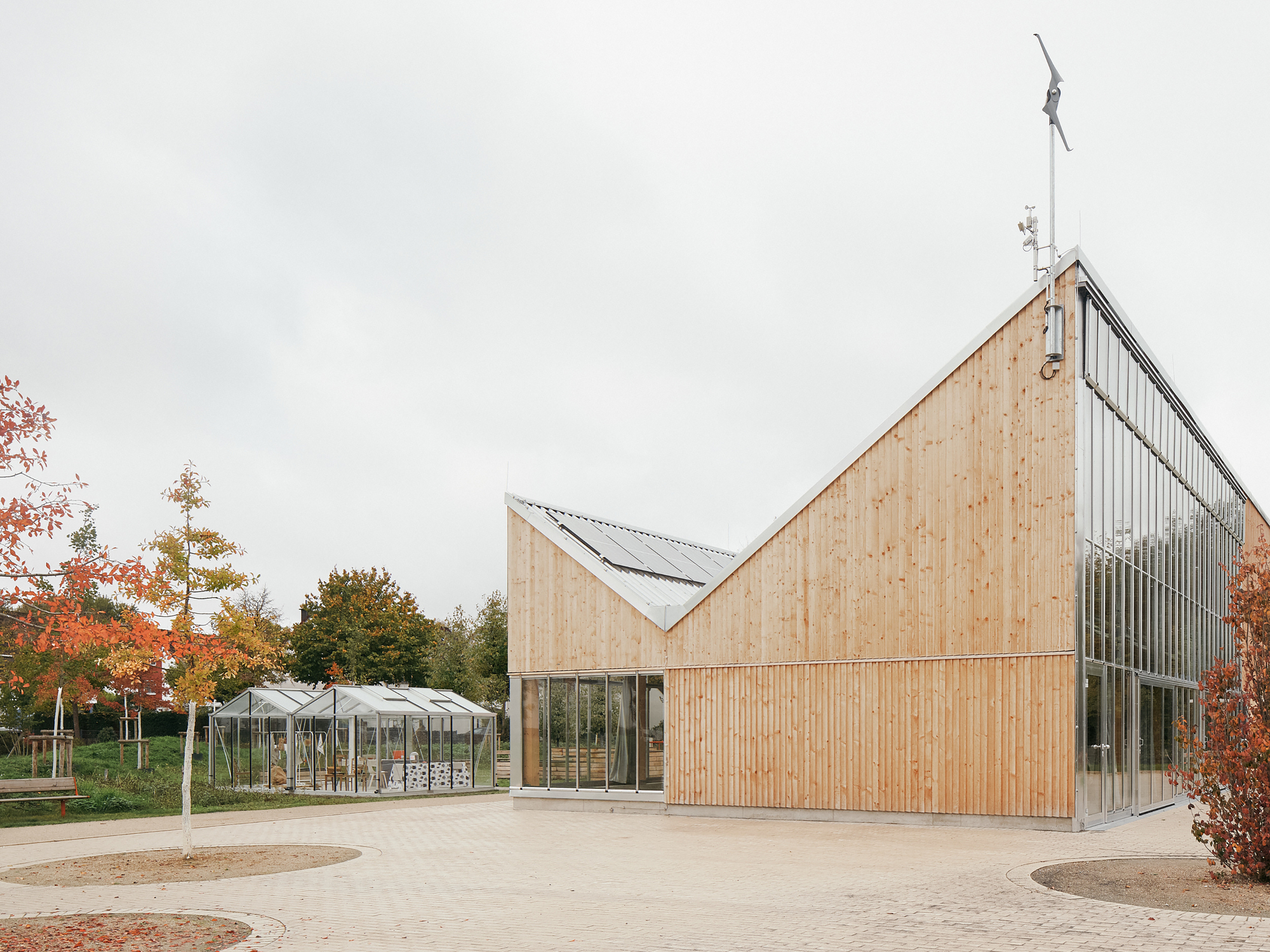 Side elevation showing the timber volume meeting the glazed greenhouse hall