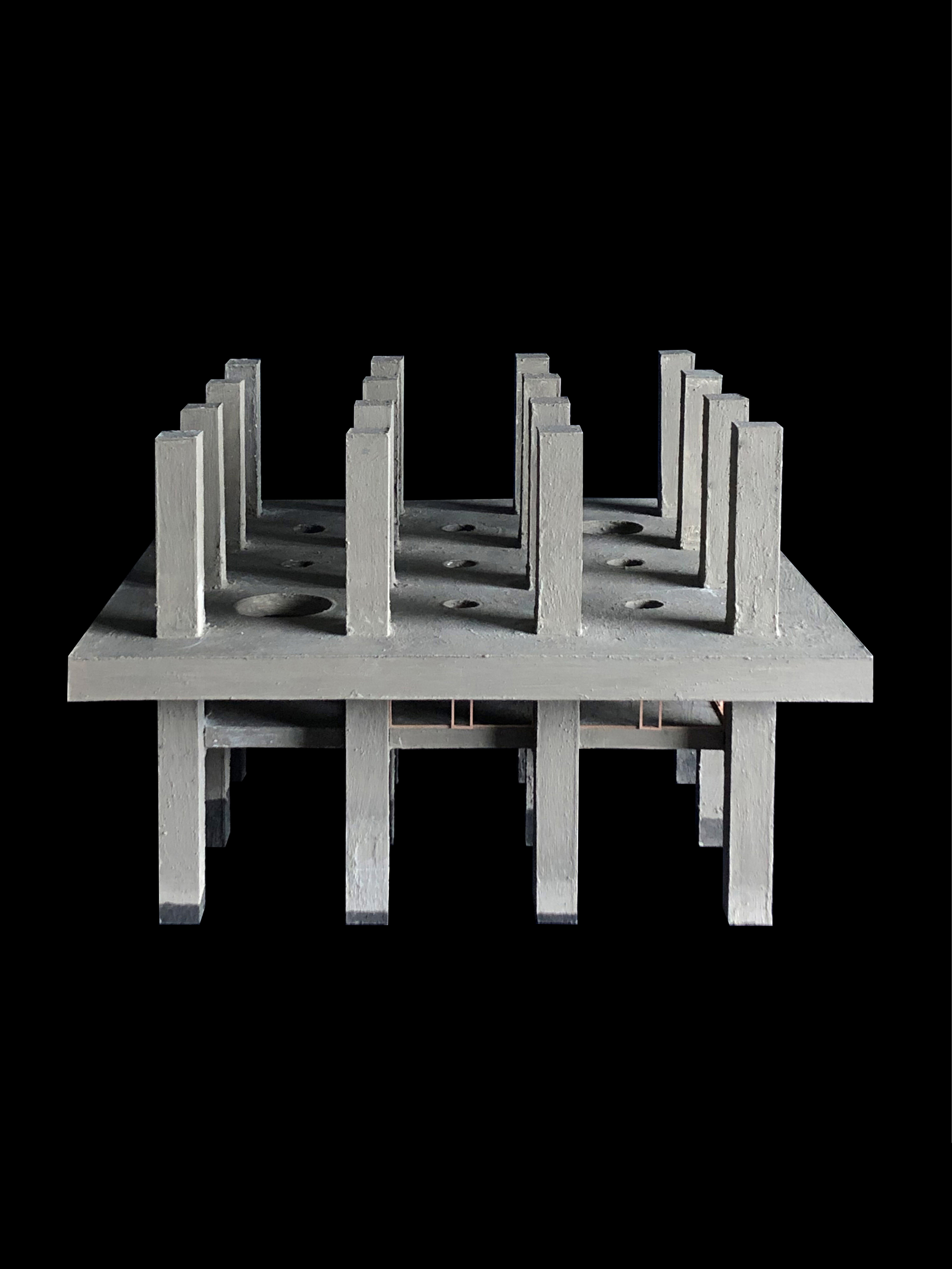 Physical model showing rows of vertical fins casting shadows across the elevated platform
