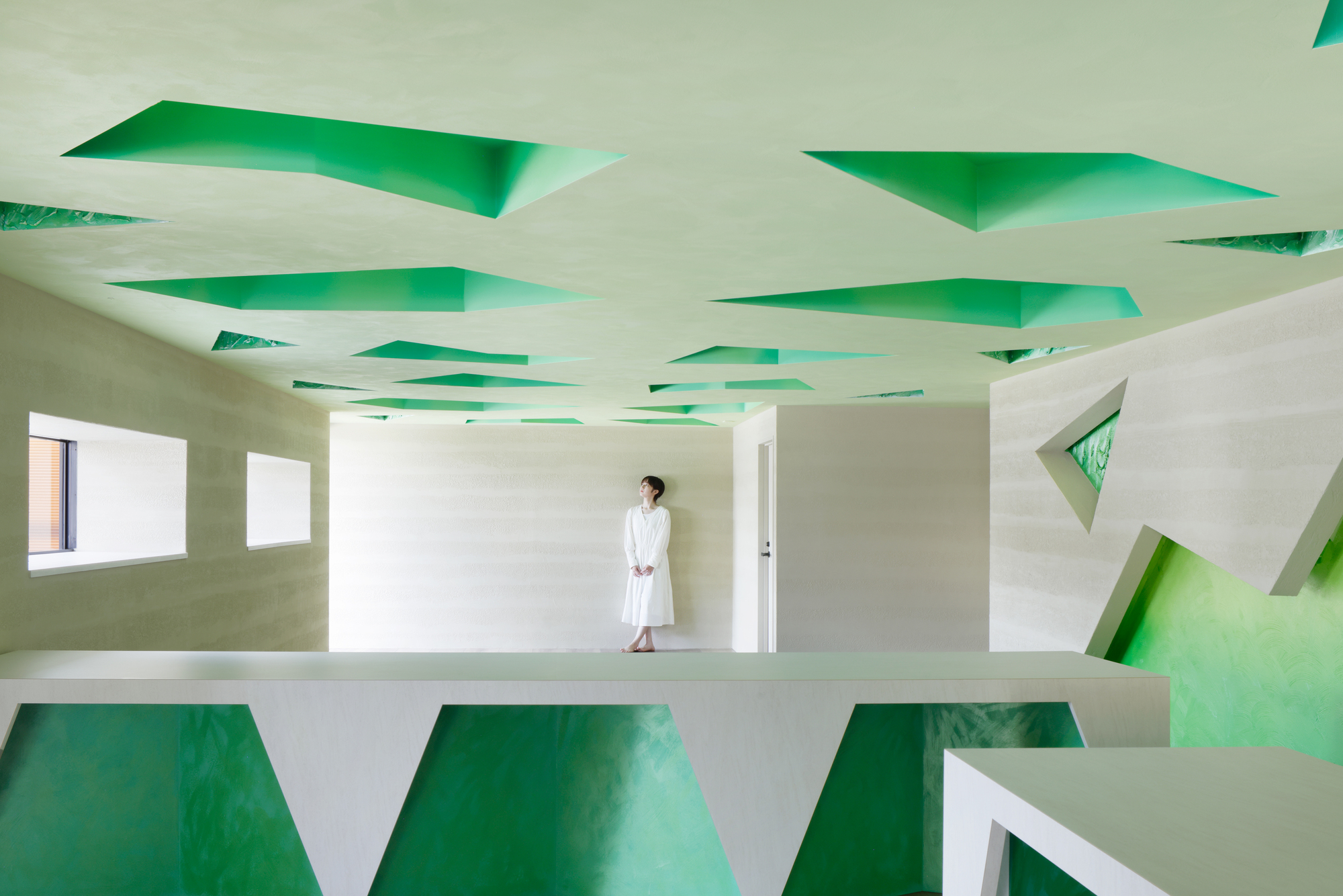 Long view across the room showing the rhythm of triangular ceiling openings