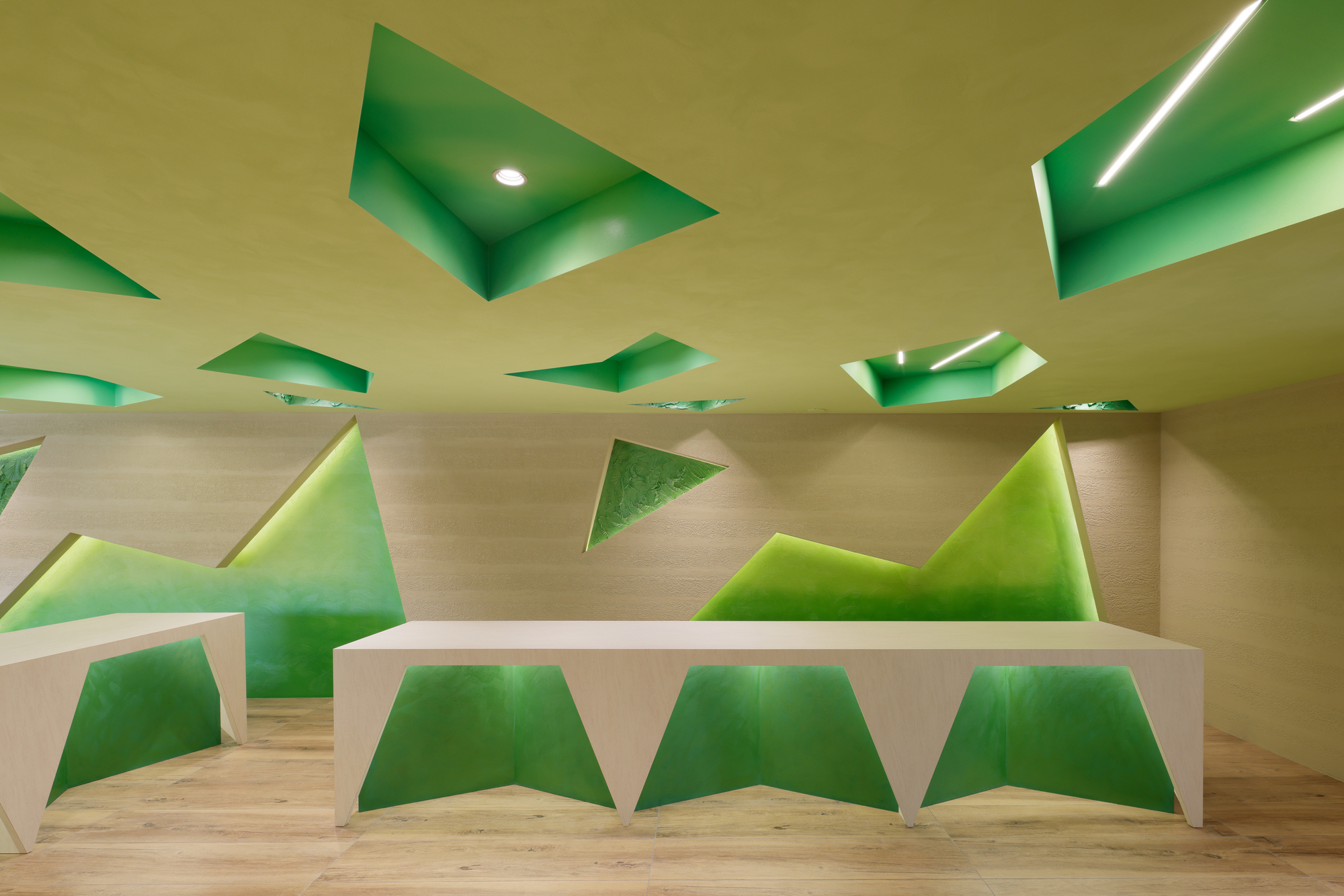 Counter and wall detail with multiple green triangle inserts at different scales