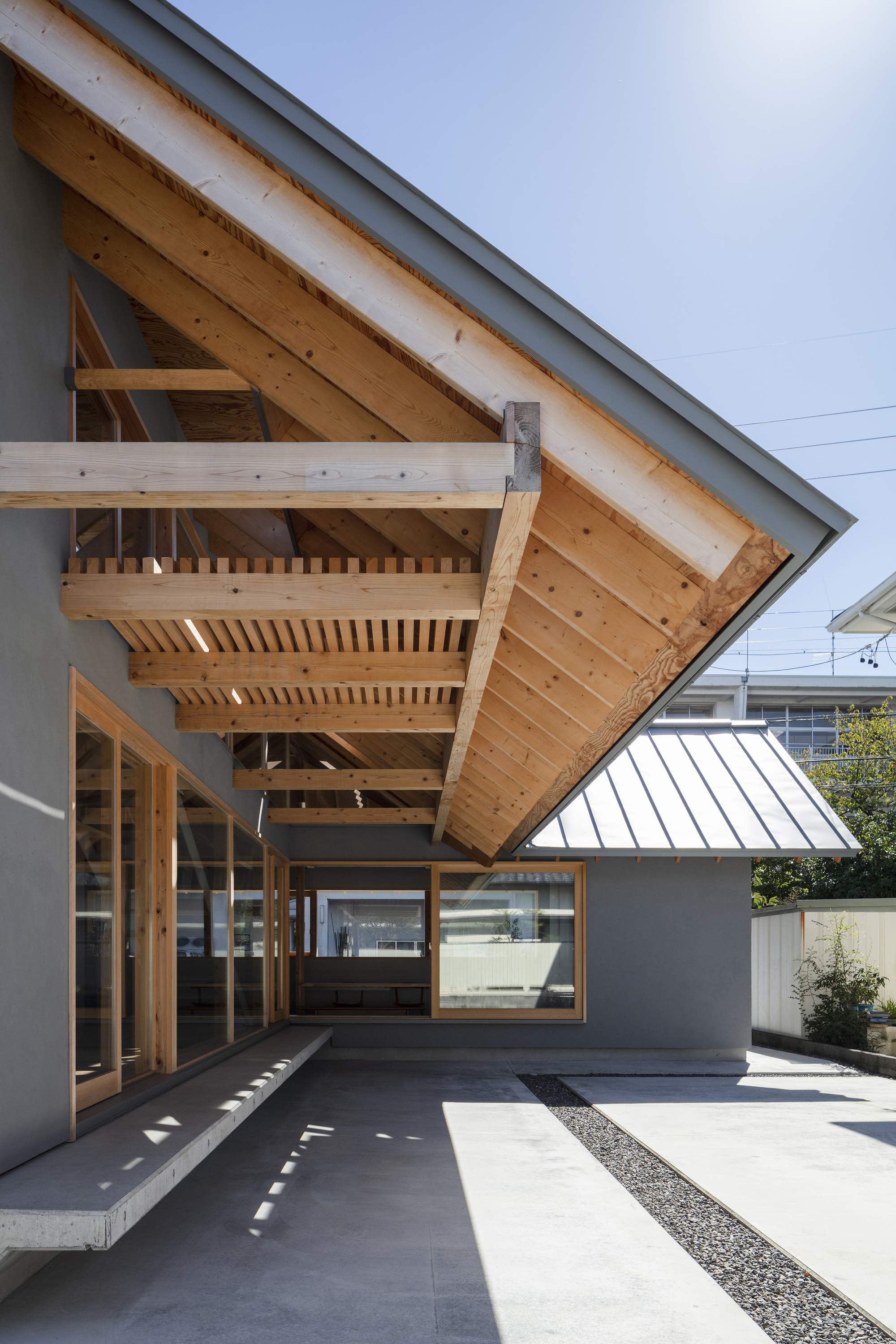 Underside of the cantilevered timber roof eave showing exposed rafters and structural joinery