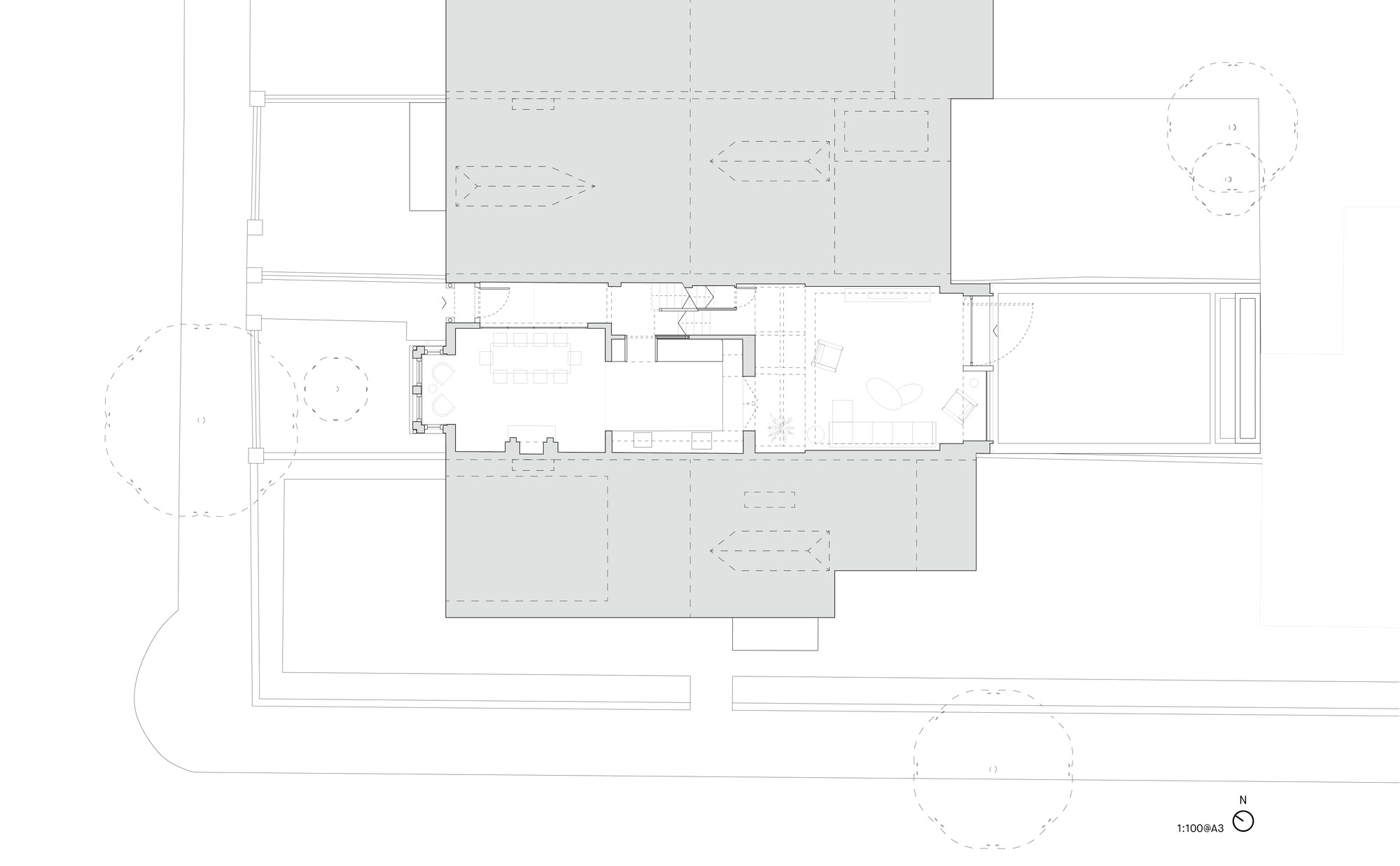 Floor plan drawing showing a central living space flanked by covered outdoor areas and landscape elements