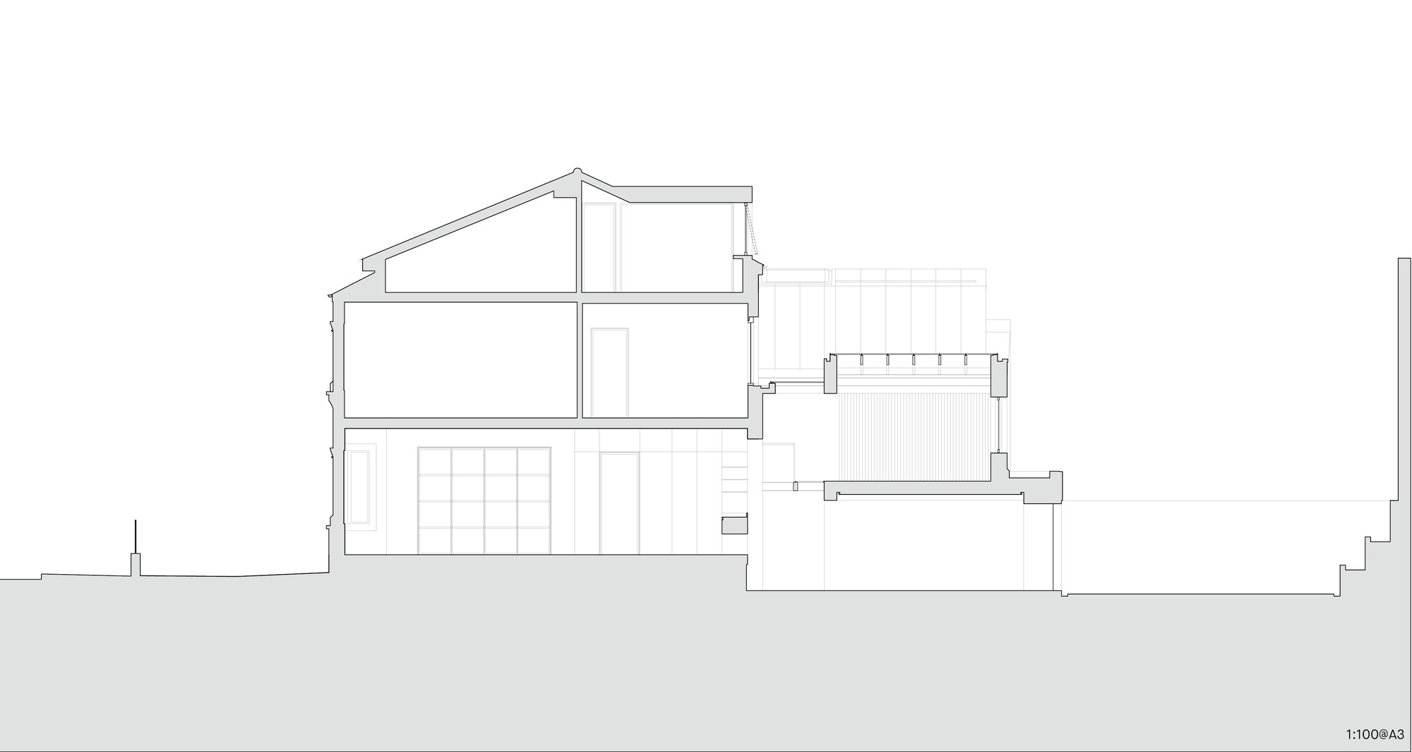 Section drawing showing a split-level house with pitched roof volumes and a lower adjoining block