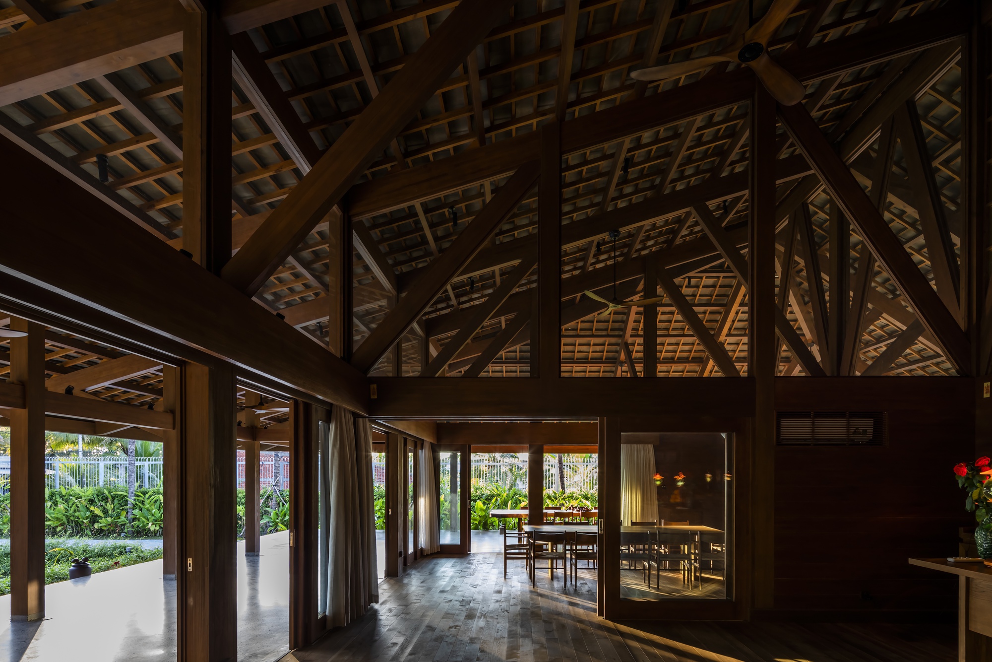 Interior view of the timber-framed dining hall illuminated at dusk