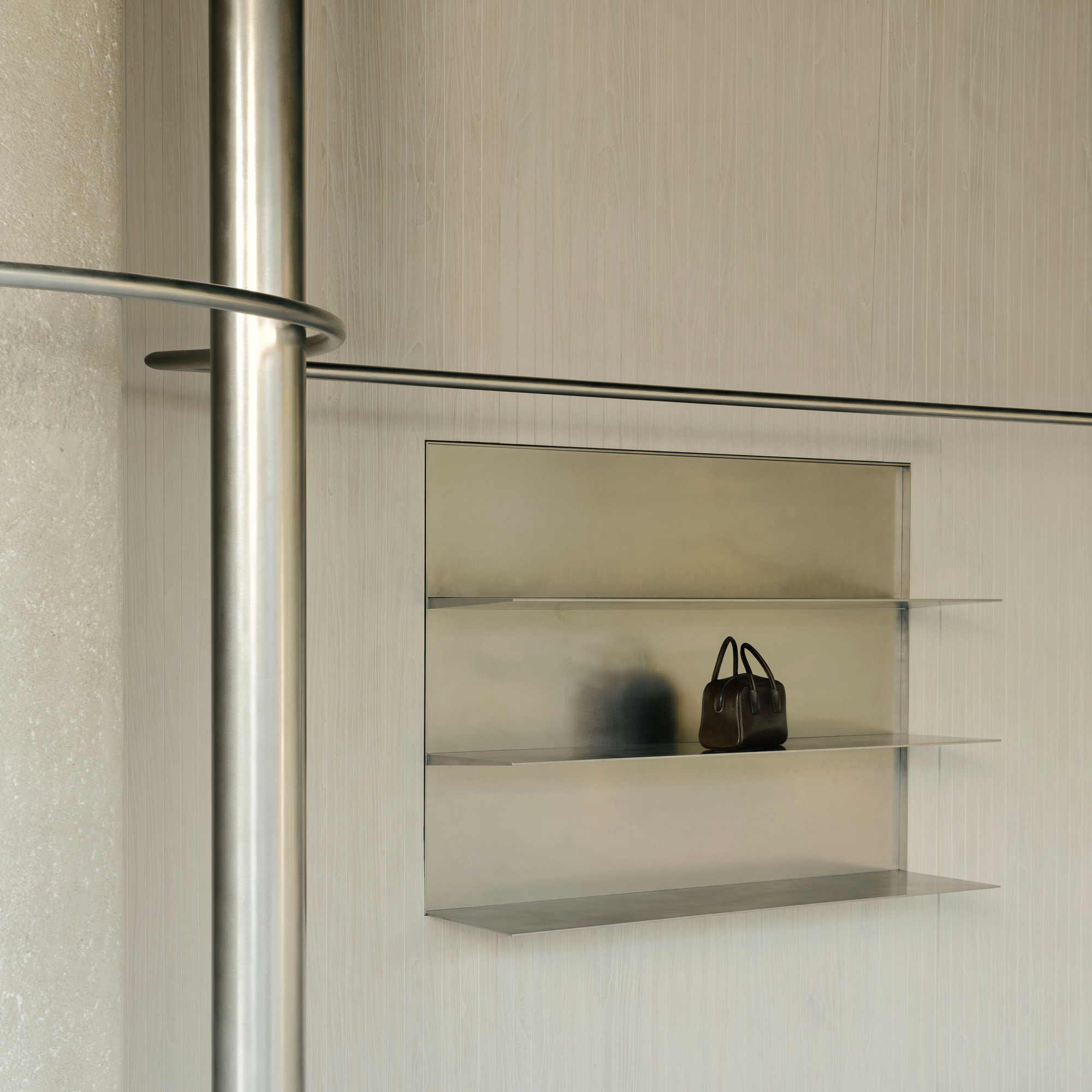 Recessed display niche with glass shelves set into the vertical grooved wall panel