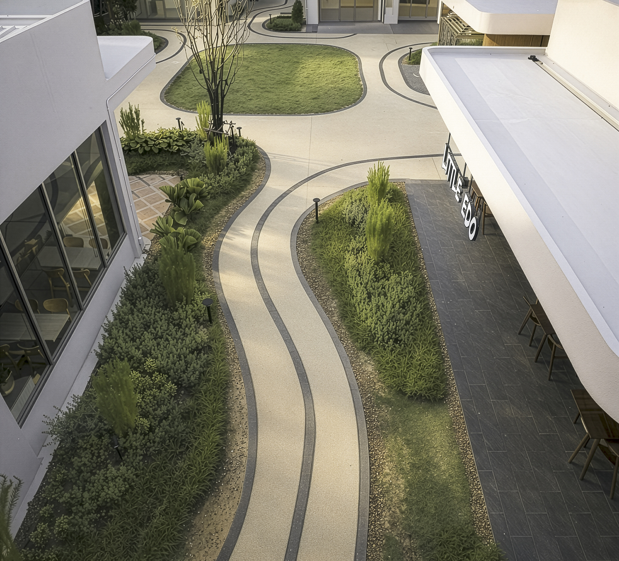 Aerial view of courtyard with curving planted beds and paved pathways between white roofed structures