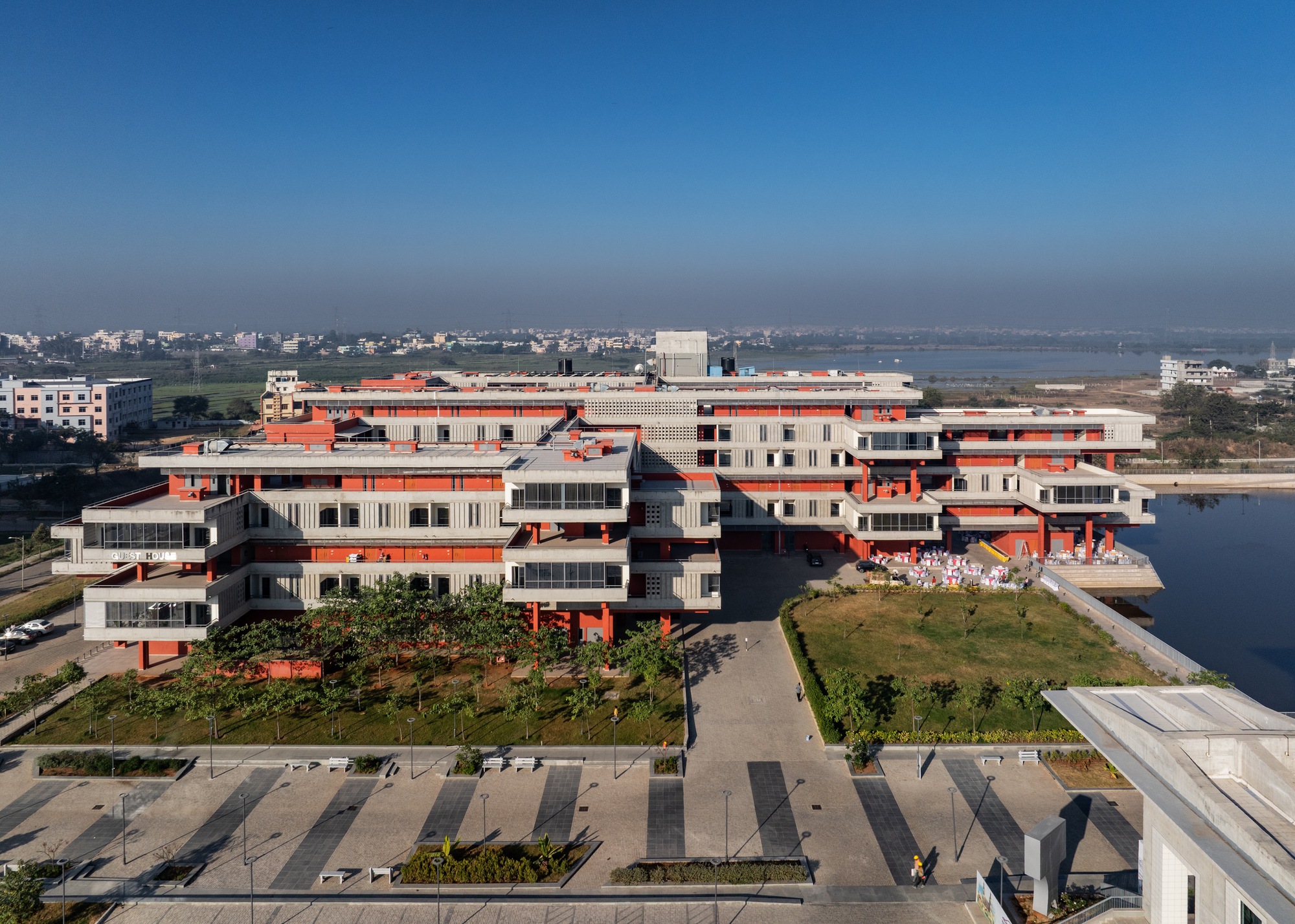 Aerial side view of the guest house with the surrounding new town in the distance