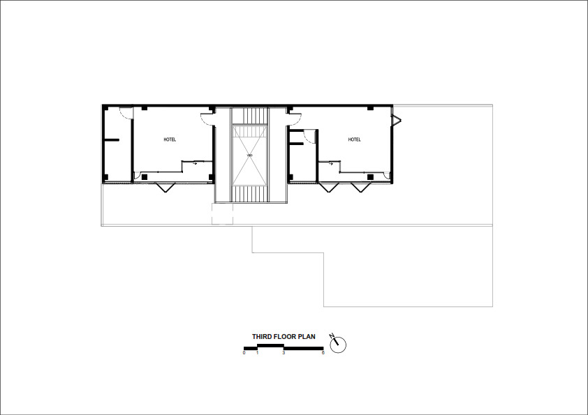 Third floor plan drawing showing two hotel rooms flanking a central stairwell