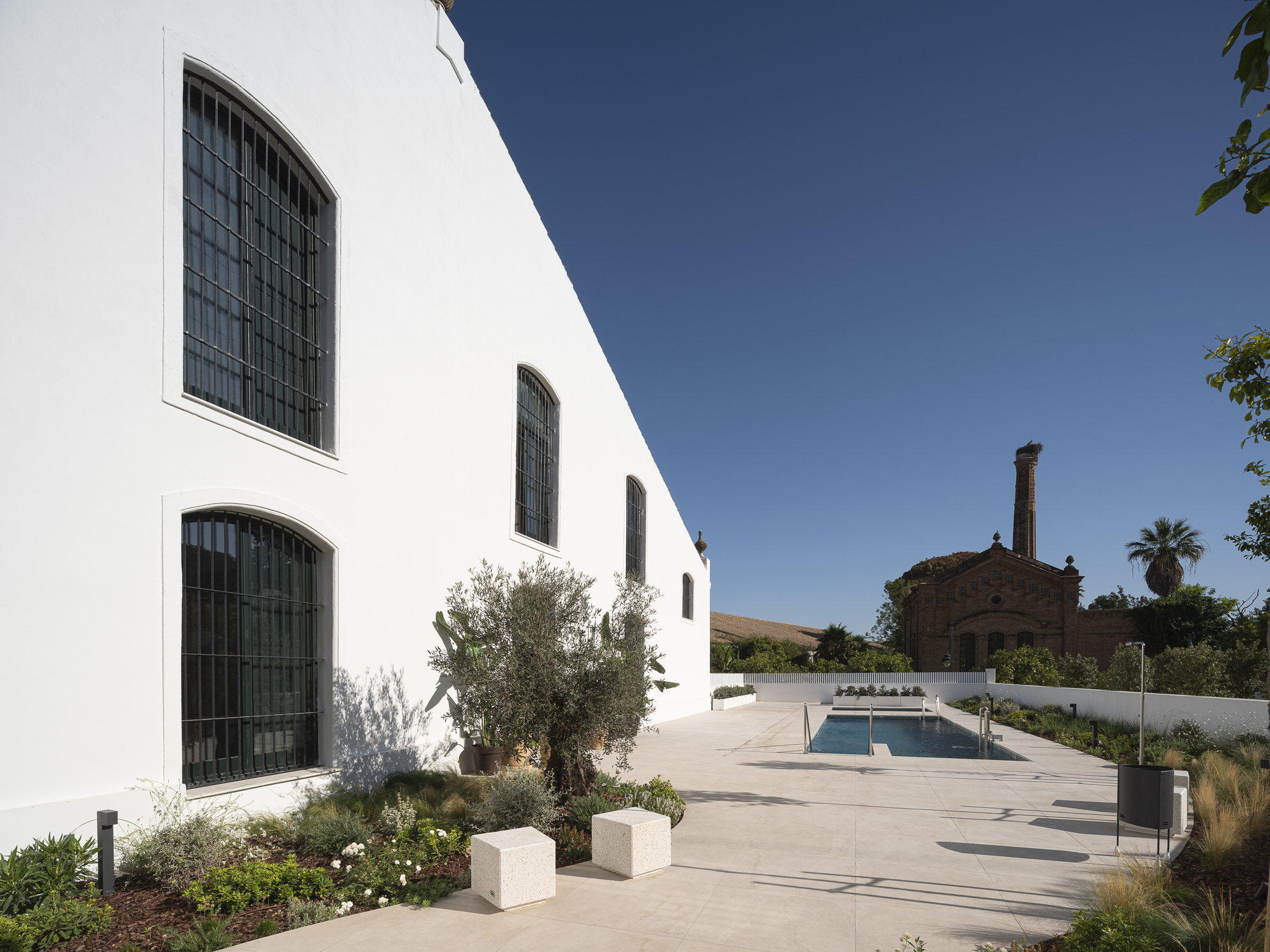 Pool terrace beside the white bodega with views to the historic chimney