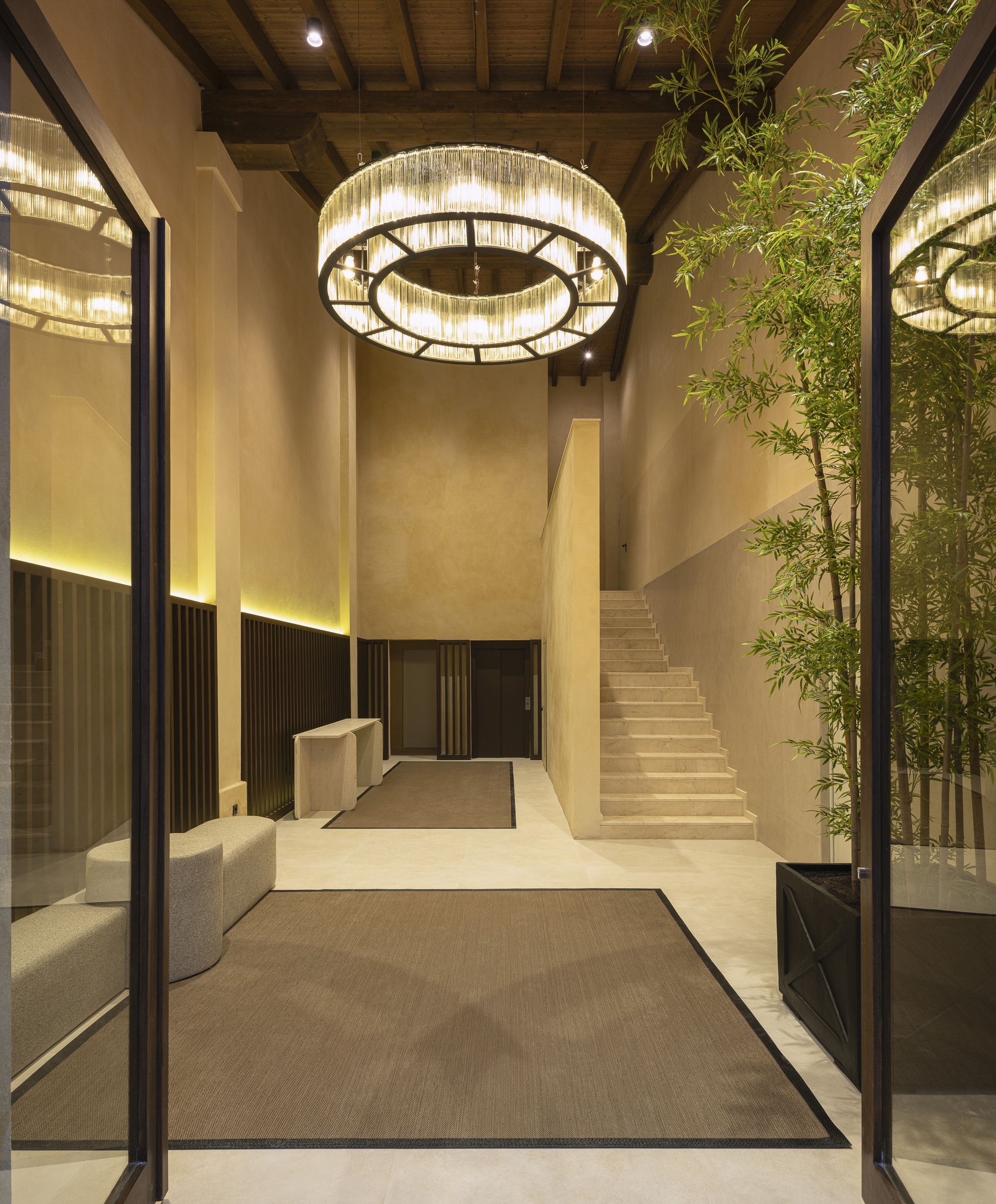 Reception lobby with circular crystal chandelier and bamboo planting