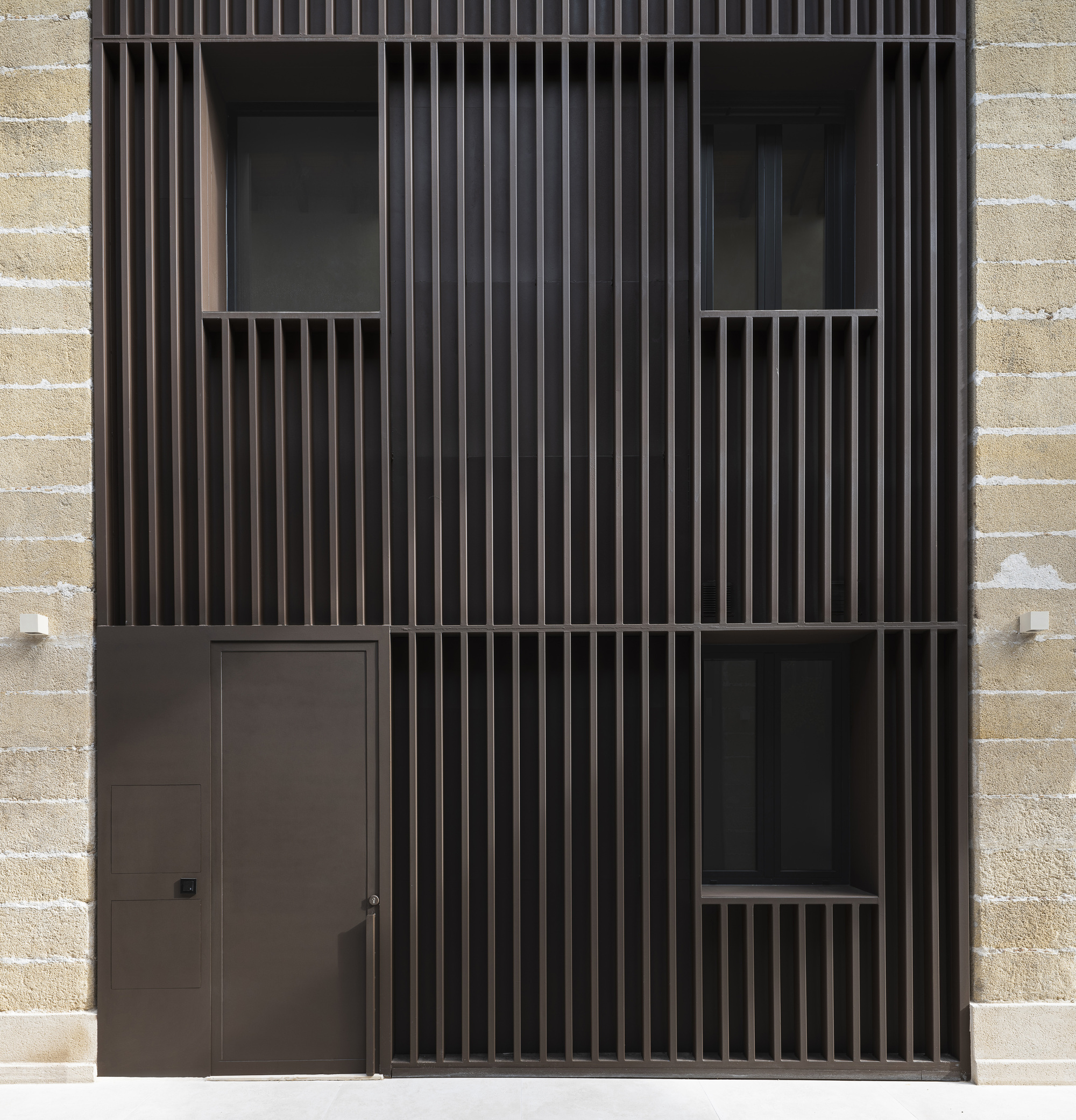 Close-up of dark timber slat screen with recessed openings