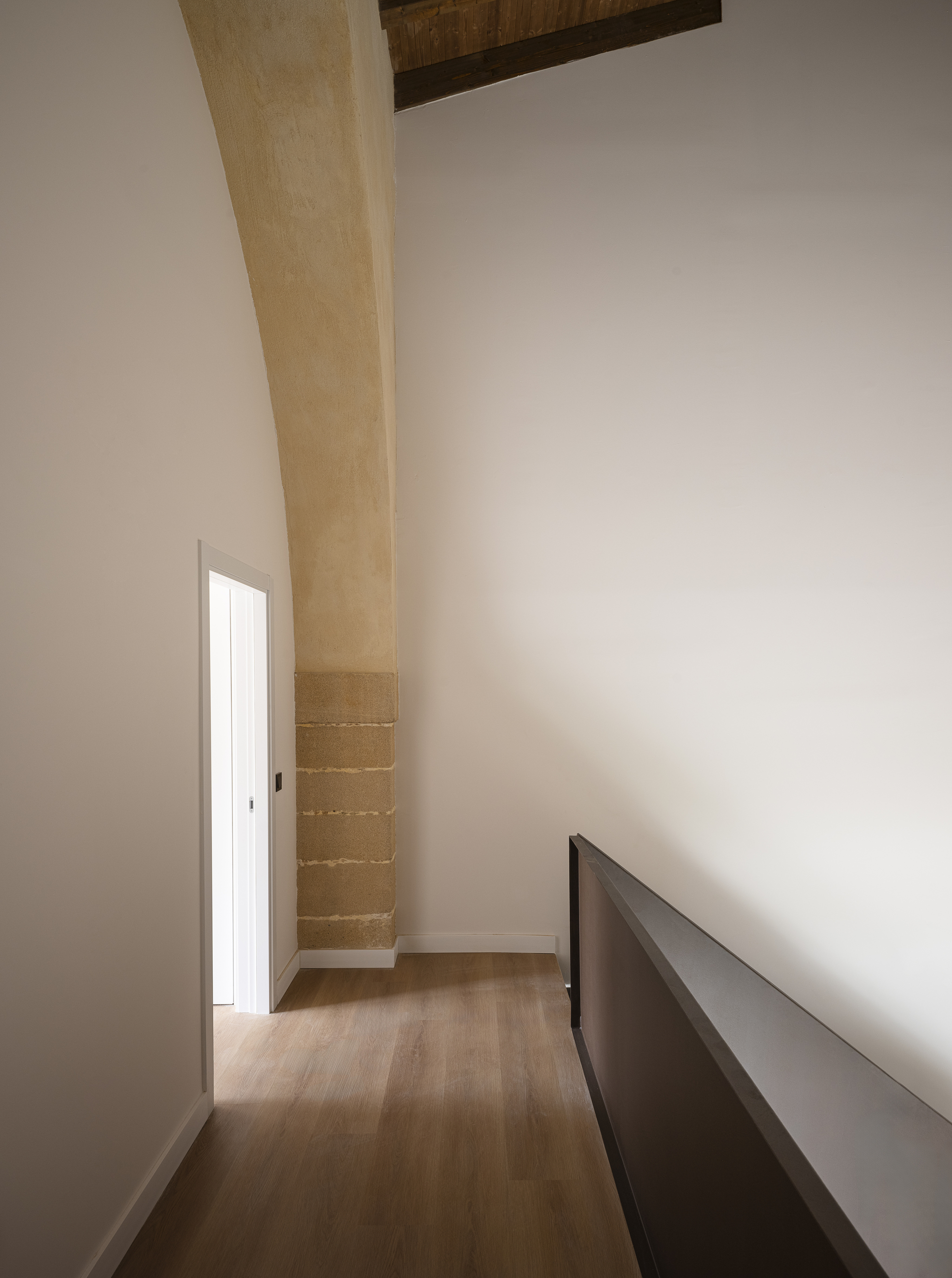 Upper interior with sandstone arch and original timber ceiling beams