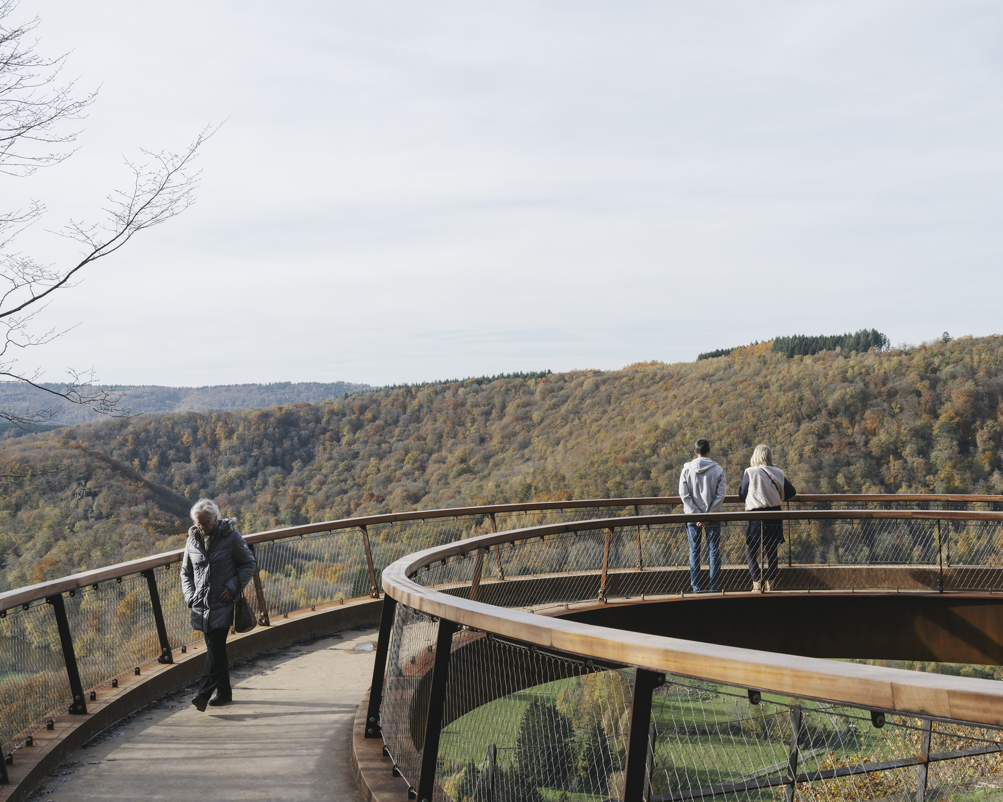 Visitors walking along the cantilevered curve of the lookout above the Semois valley