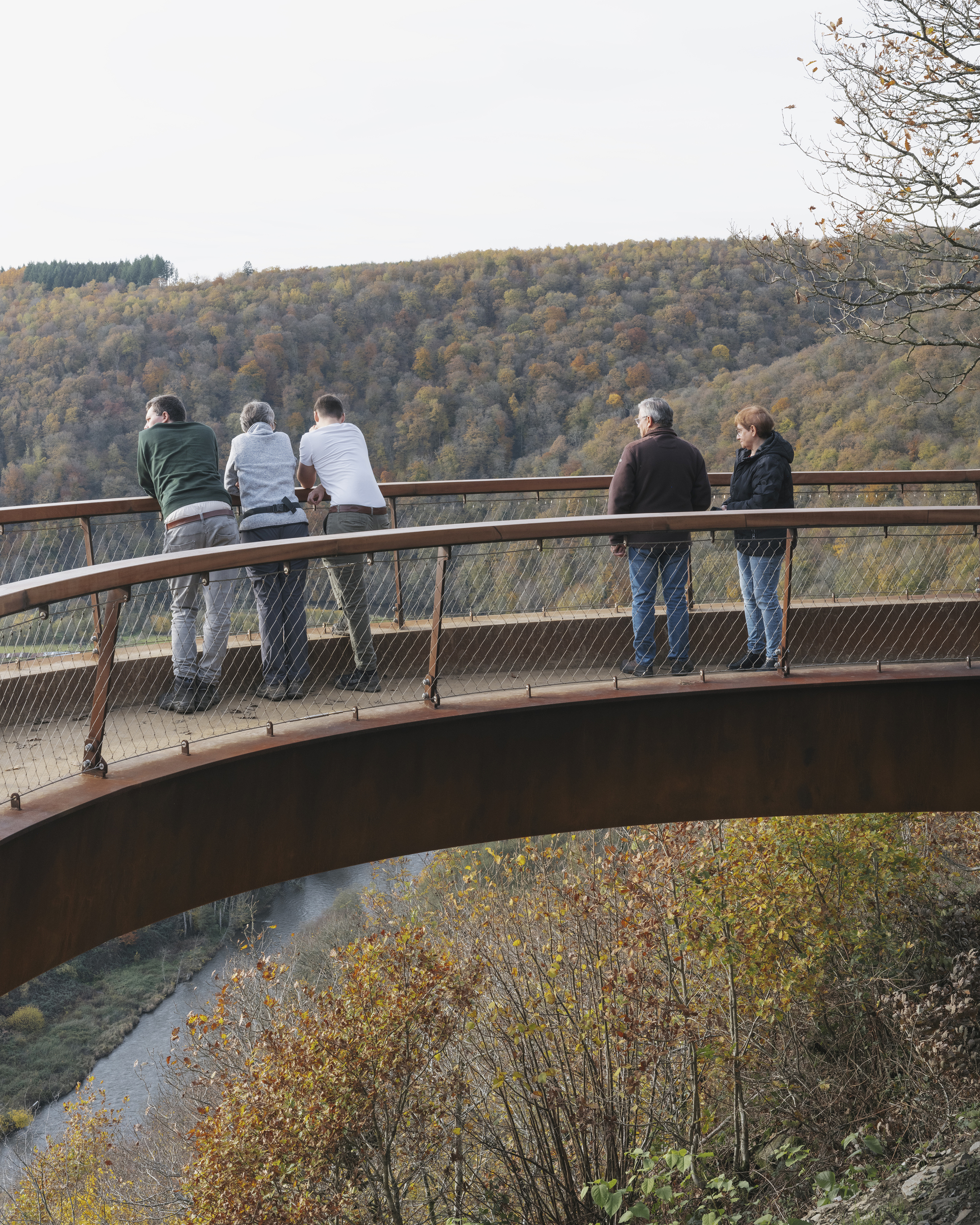Small group standing at the railing on the cantilevered tip of the curve