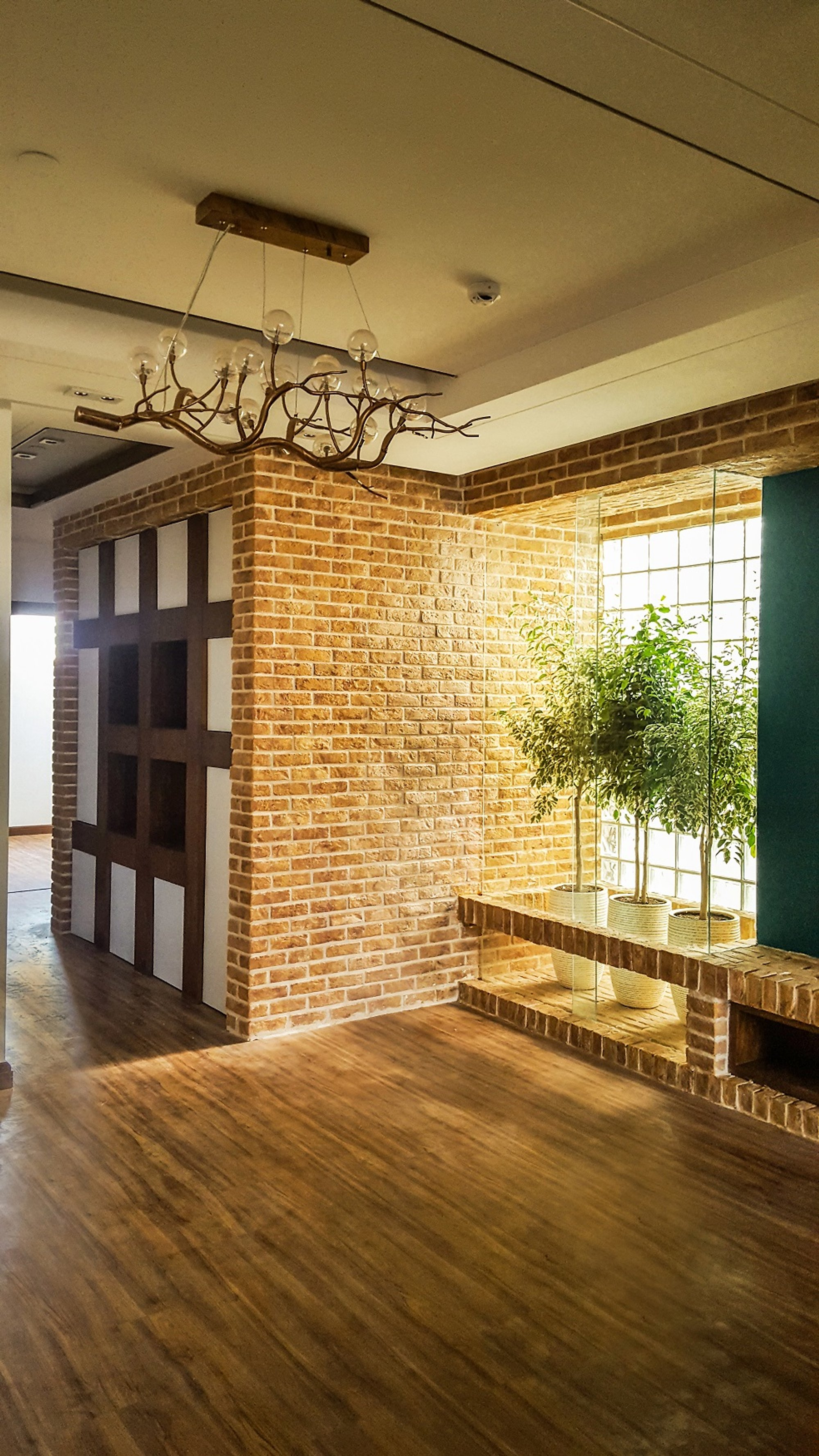 Exposed brick walls define the spatial core, bringing warmth and texture to this modern interior design.
