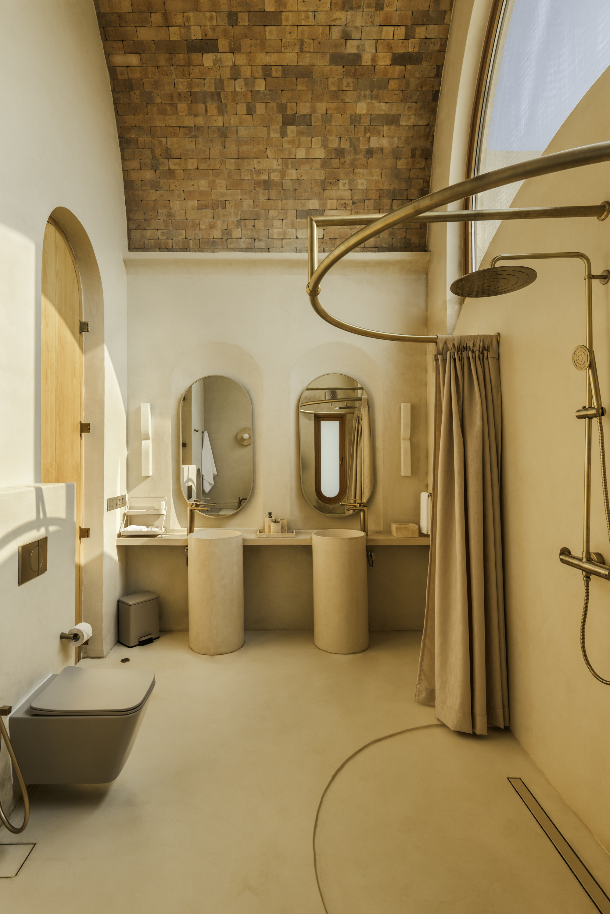 Bathroom interior with woven timber ceiling panel and polished plaster twin vanities