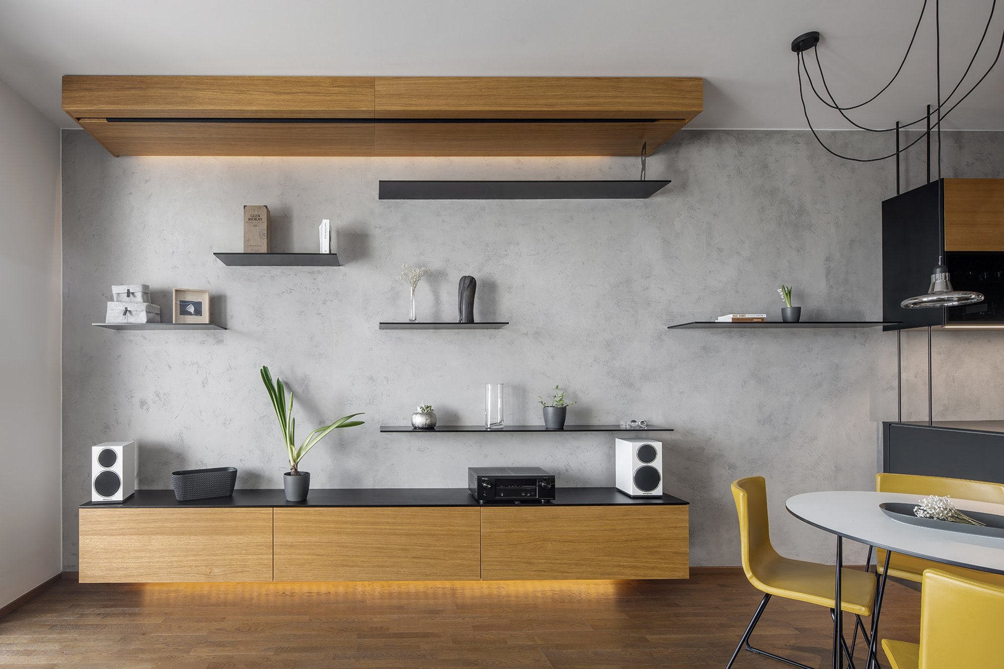 Minimal living wall with floating shelves and warm underlighting