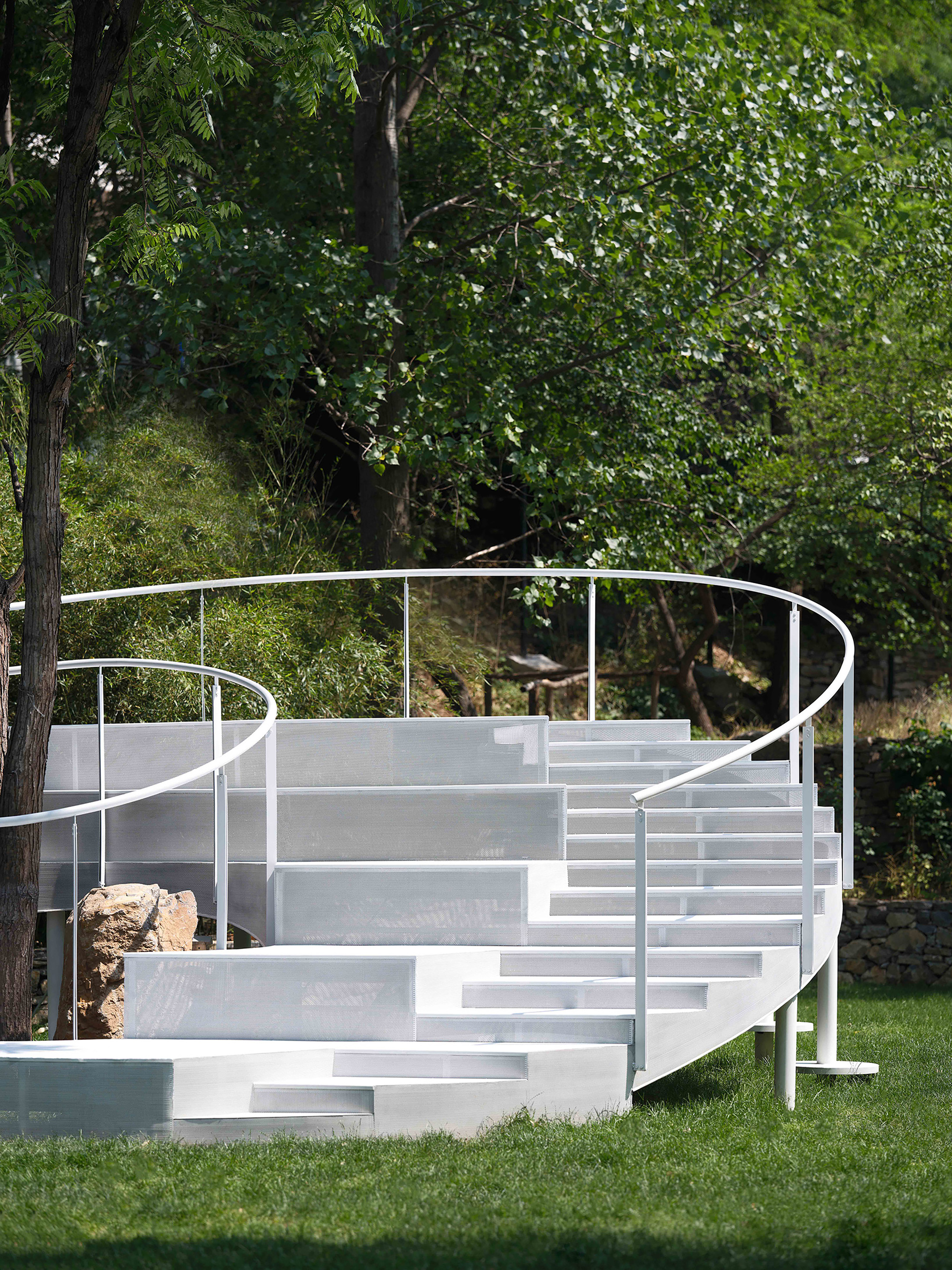 Side view of the helical staircase showing staggered treads and dual curving railings