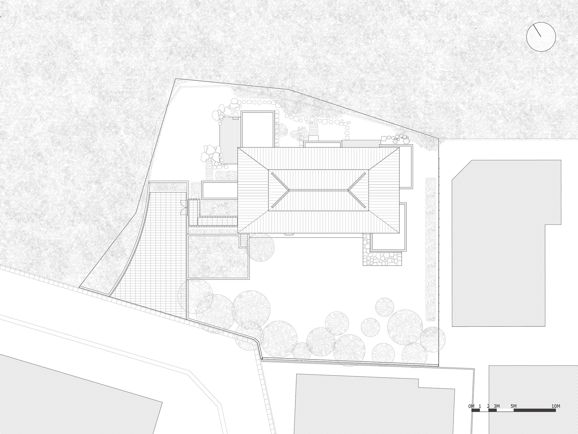 Roof plan drawing showing the angled metal roofs and surrounding garden with trees