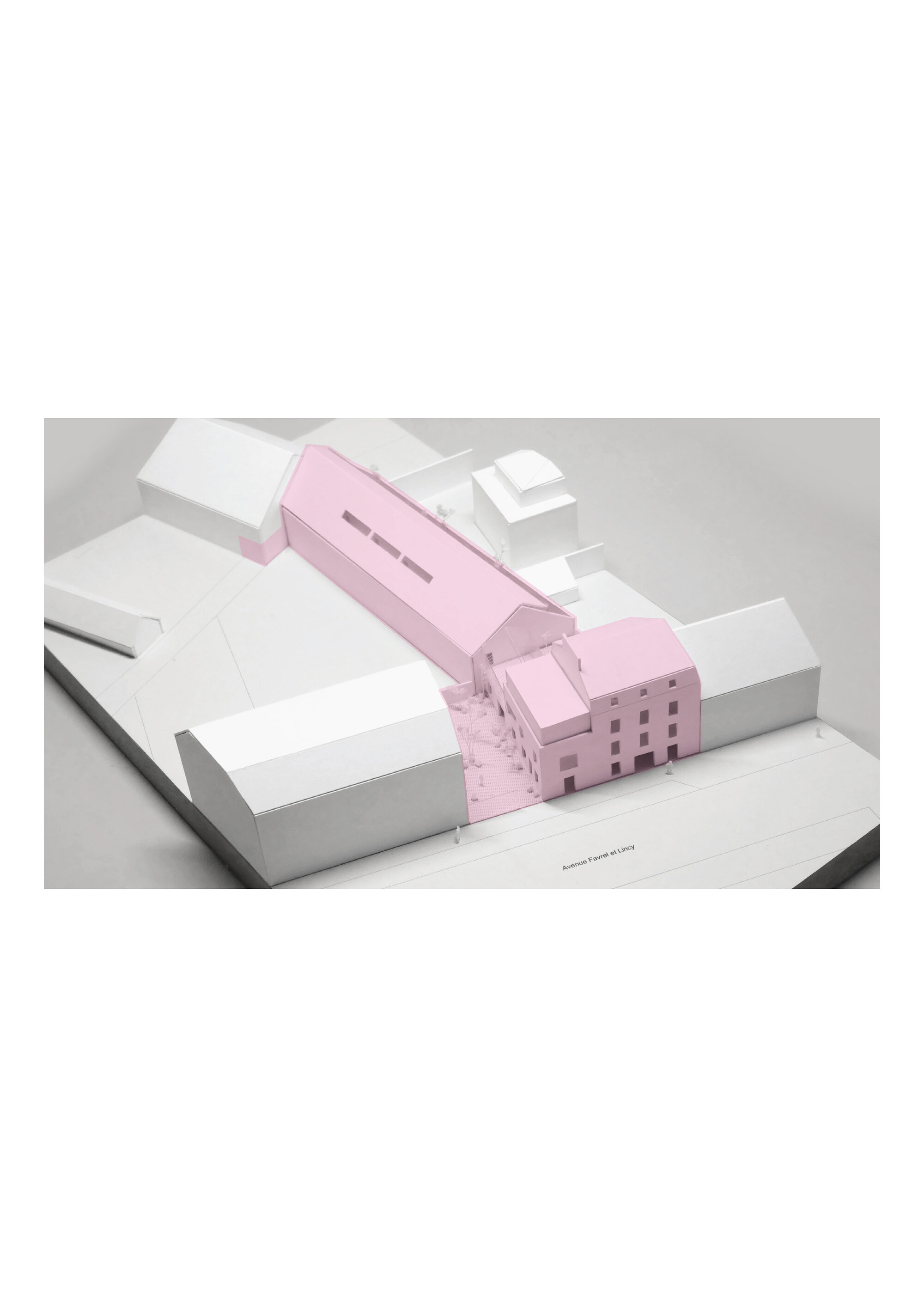 Physical model showing pink volumes inserted between white building masses on a white base