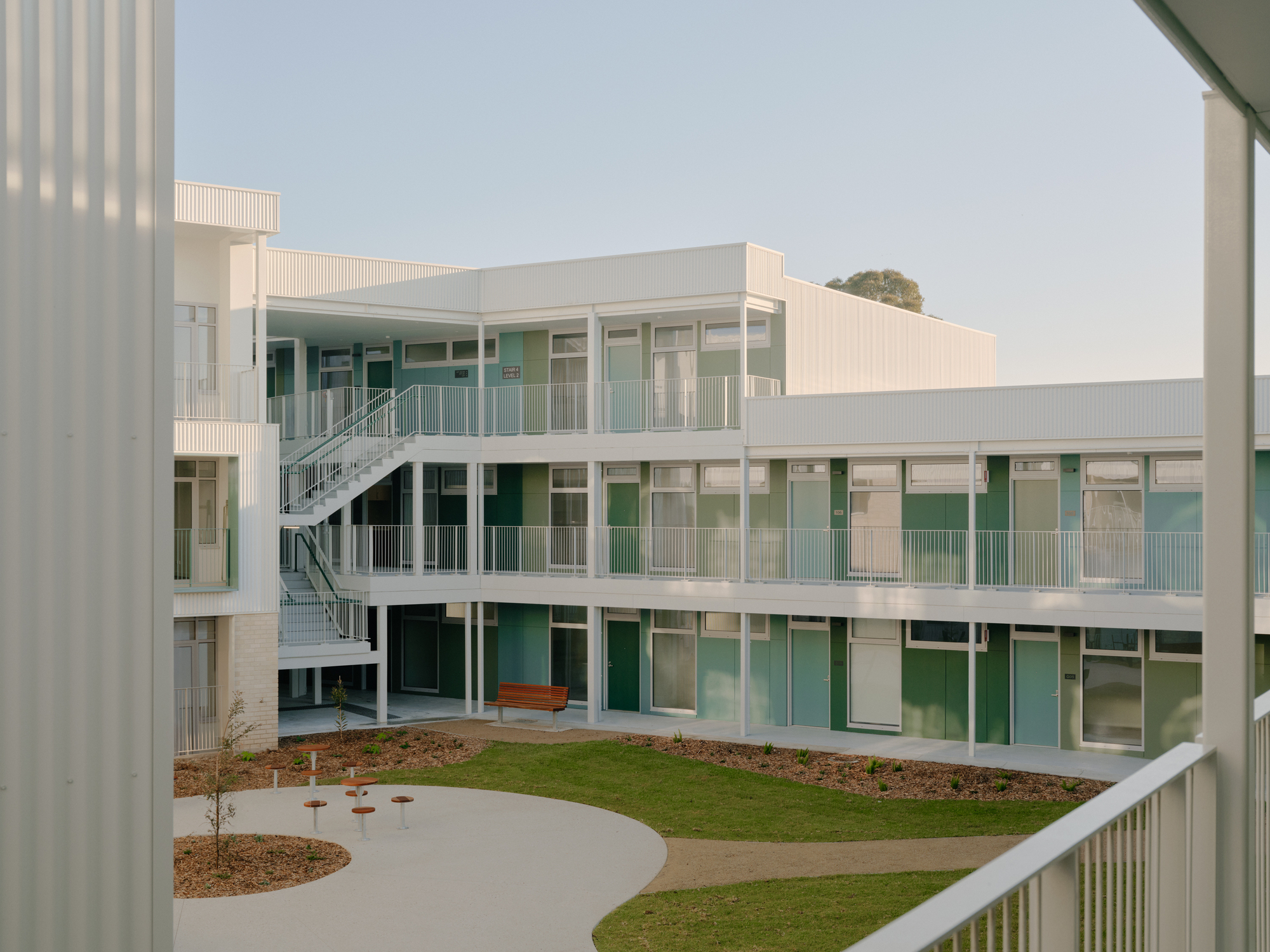 View across courtyard showing external staircase and glazed access galleries