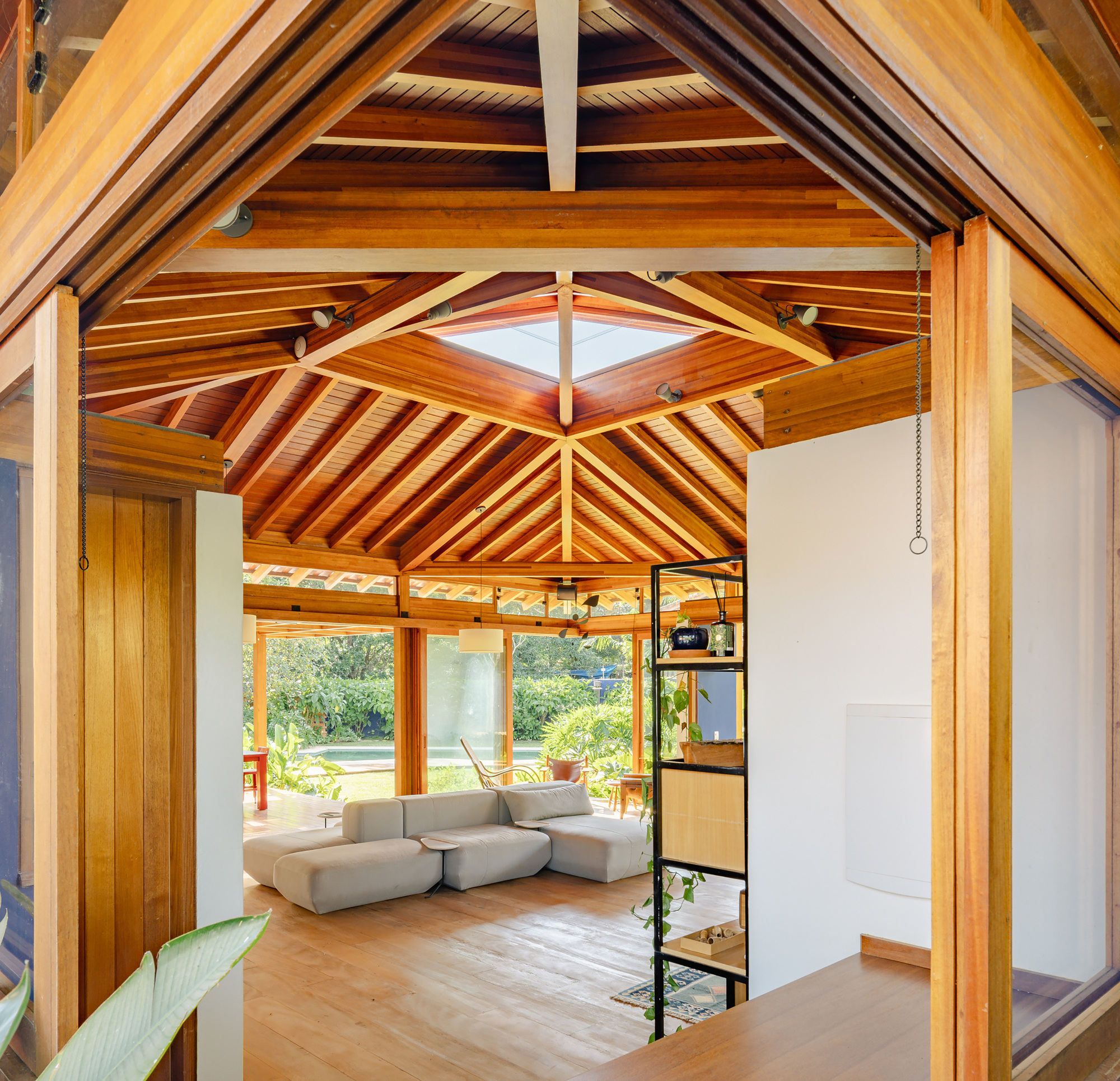 Interior view through doorway to living space with exposed timber roof rafters and skylight above