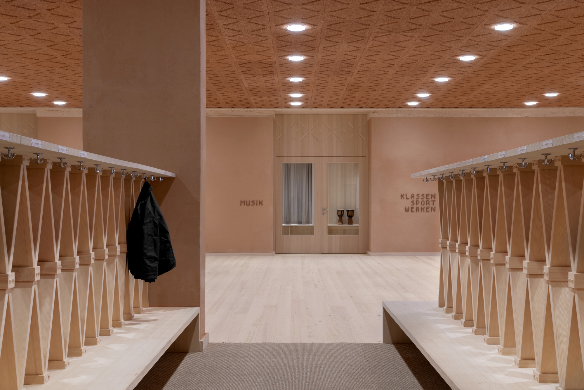 Entrance hallway with turned wood balustrades, bench seating, and a black jacket hung on the railing