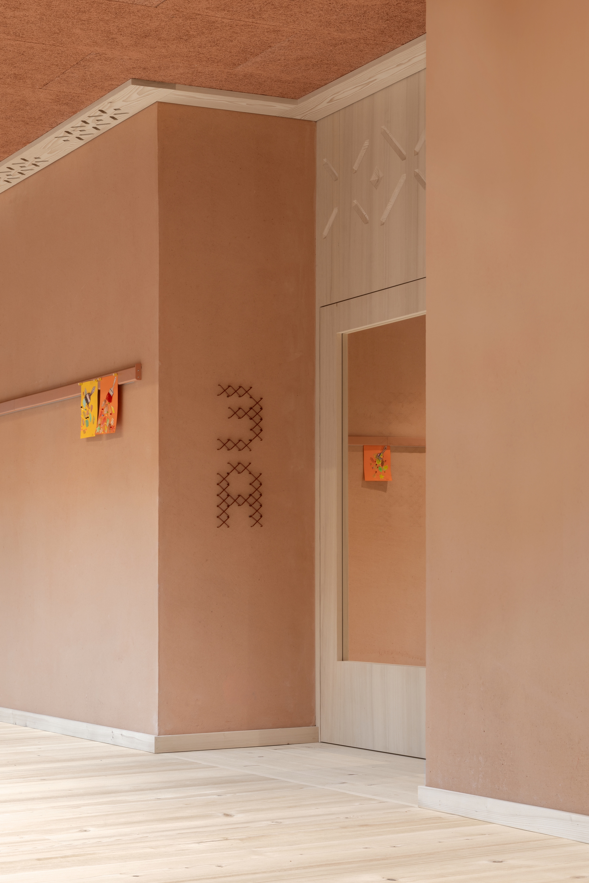 Interior corner with plywood walls, a small mirror, and terracotta ceiling illuminated by soft natural light