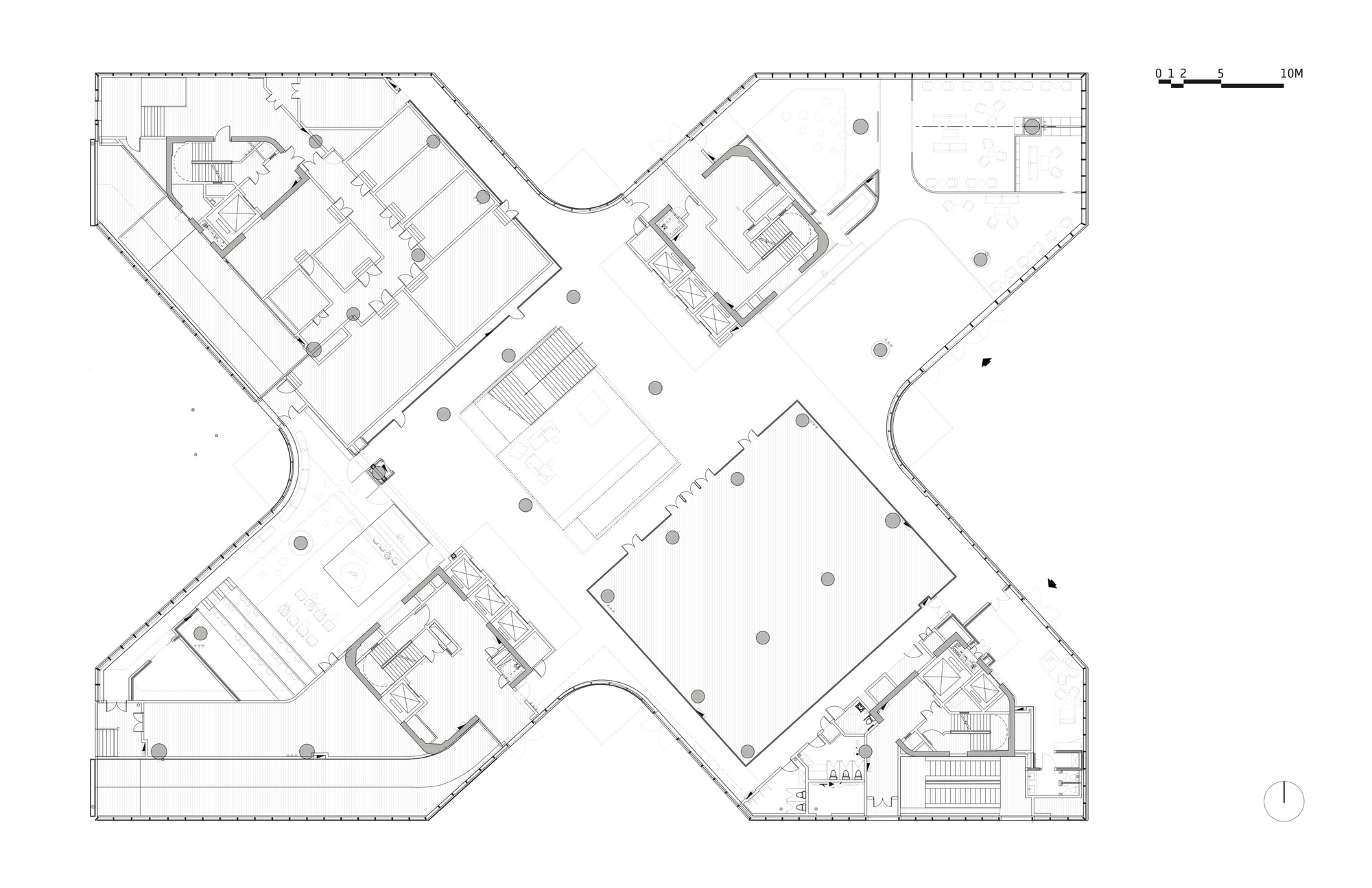 Floor plan drawing showing four radiating wings arranged around central circulation spaces and courtyards